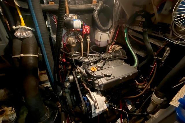 Engine compartment of a 1988 Morgan 44 sailboat, showcasing intricate mechanical components.