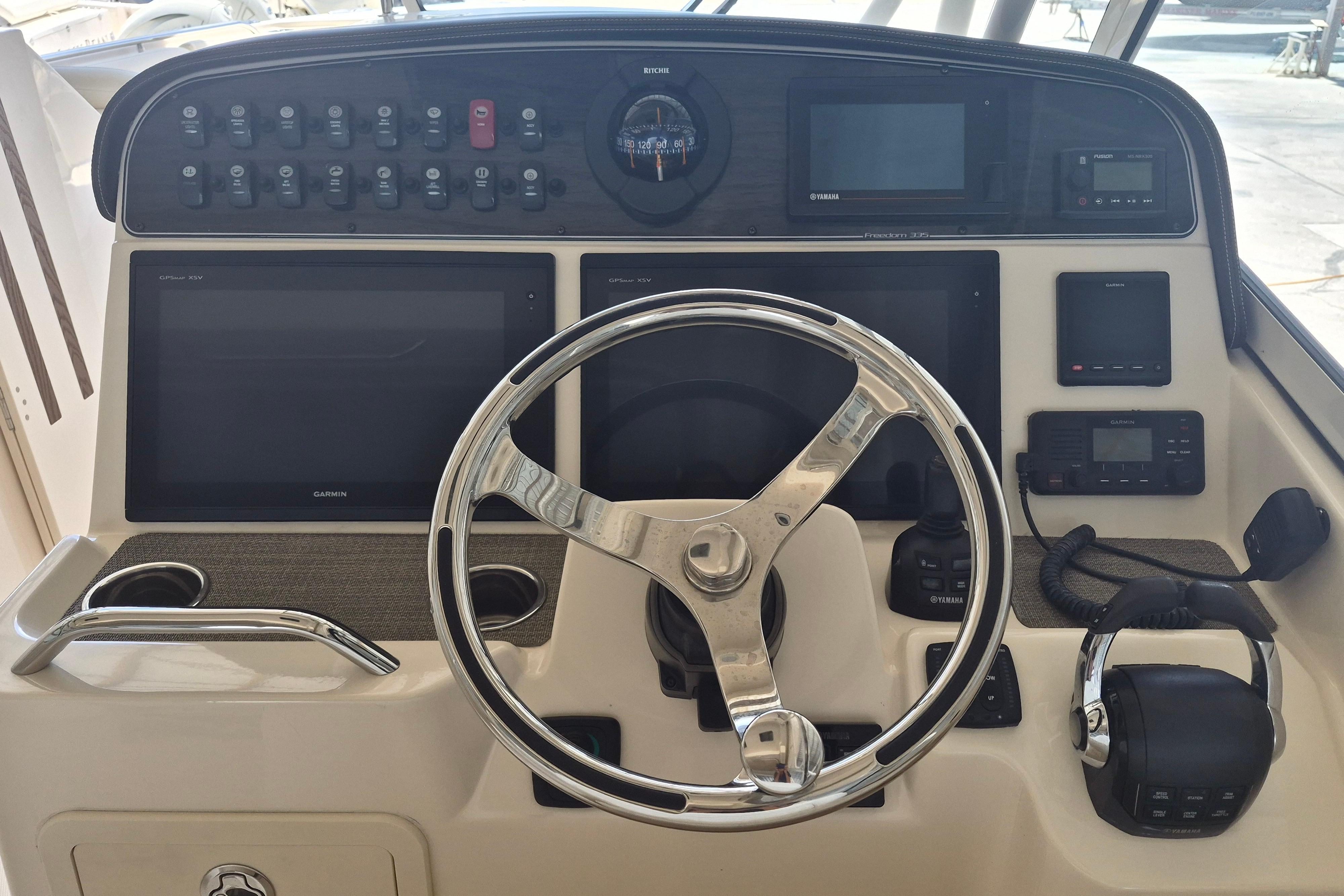 2019 Grady-White Freedom 335 helm with steering wheel and navigation controls.