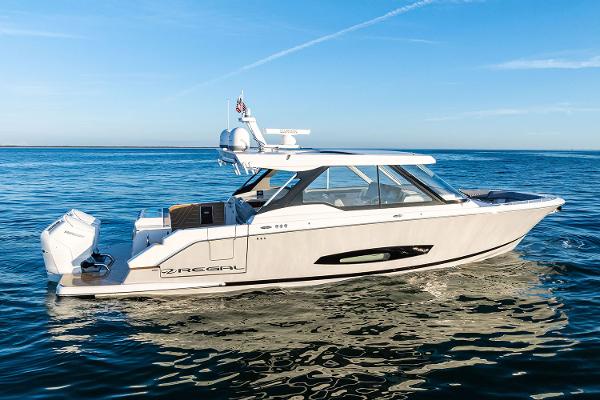 Manufacturer Provided Image: 2026 Regal LX43 boat cruising on calm blue waters under clear skies.