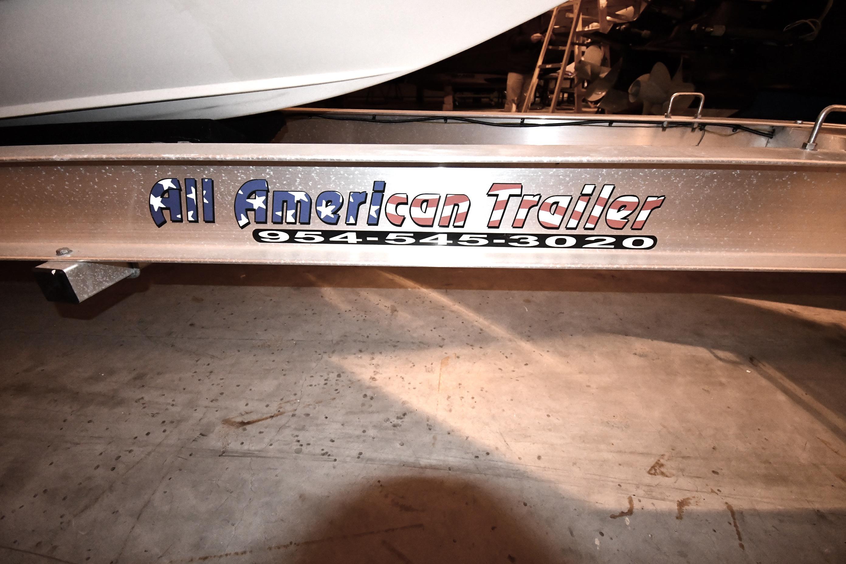 Trailer with "All American Trailer" logo, showcasing a 2001 Fountain 38 Center Console boat.
