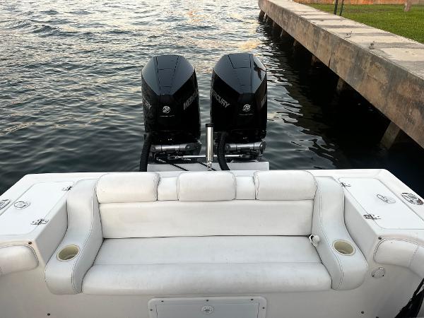 2001 Concept 30 PF Sport boat with twin Mercury engines, white seating, docked by water.