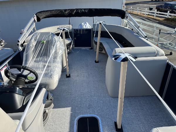 2025 Harris Cruiser 230 pontoon boat interior with seating and steering wheel.