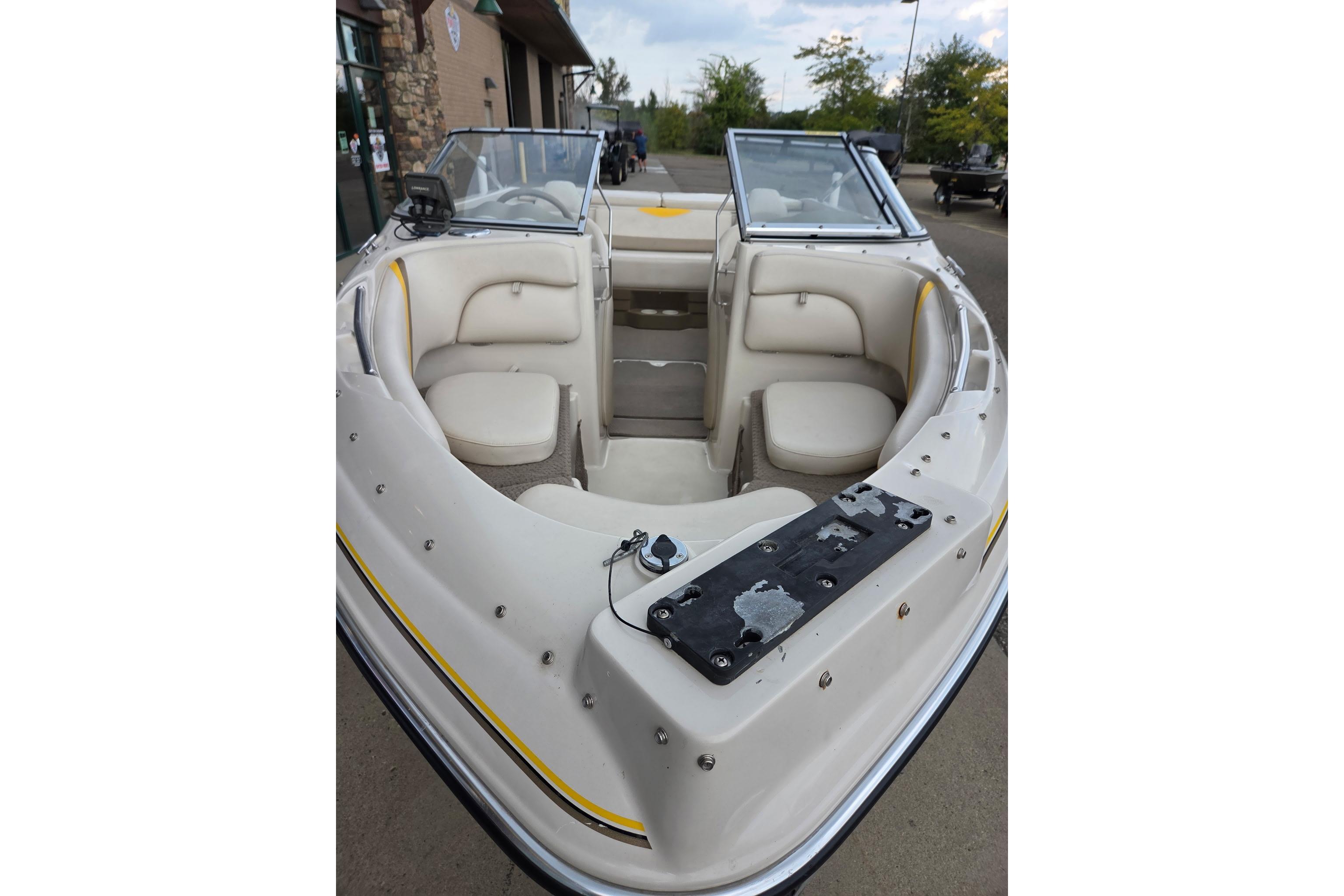 2003 Glastron GX185SF boat interior with beige seating and windshield.