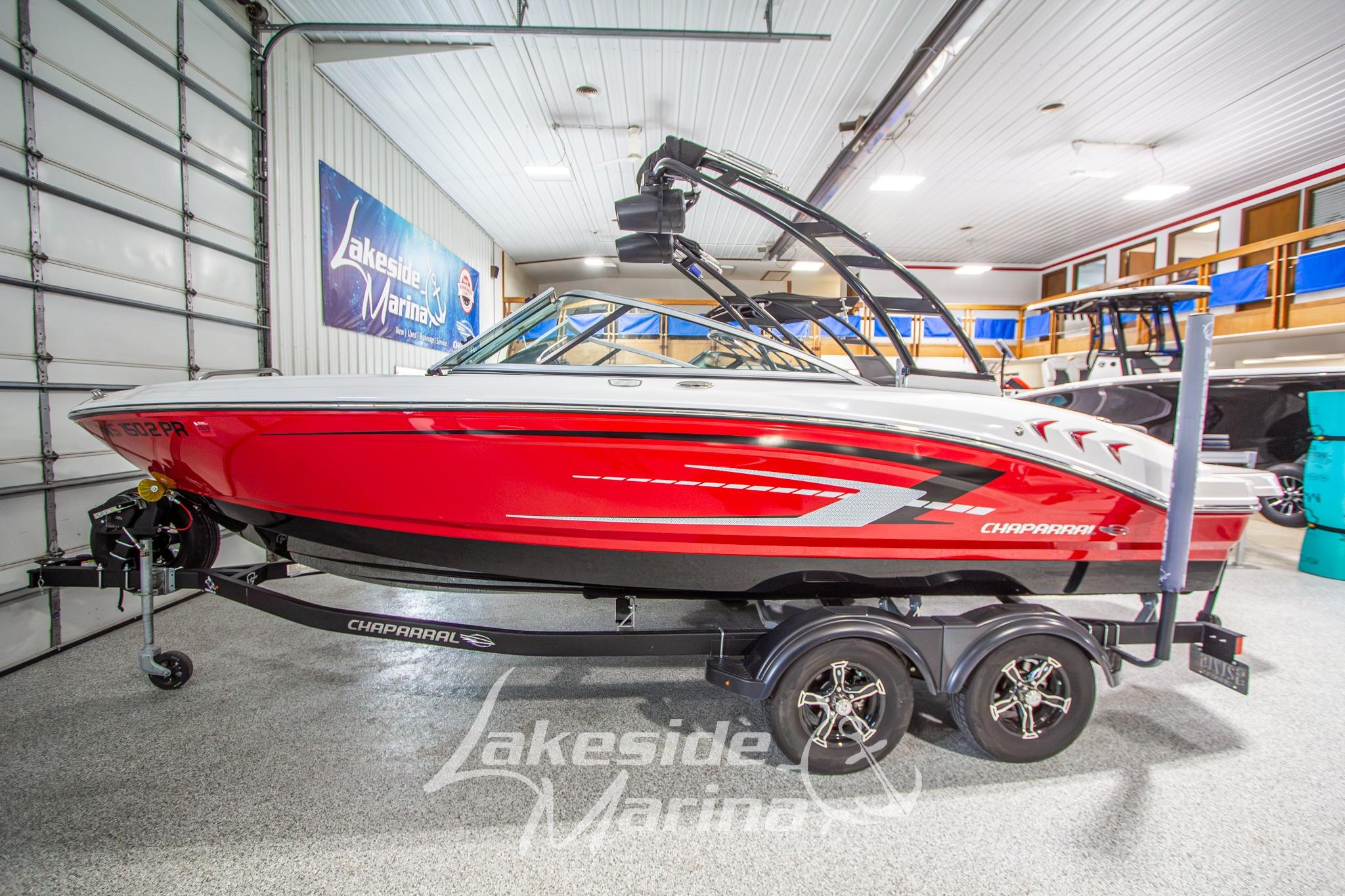 2022 Chaparral 21 SSi boat in showroom, red and black design, on trailer at Lakeside Marina.