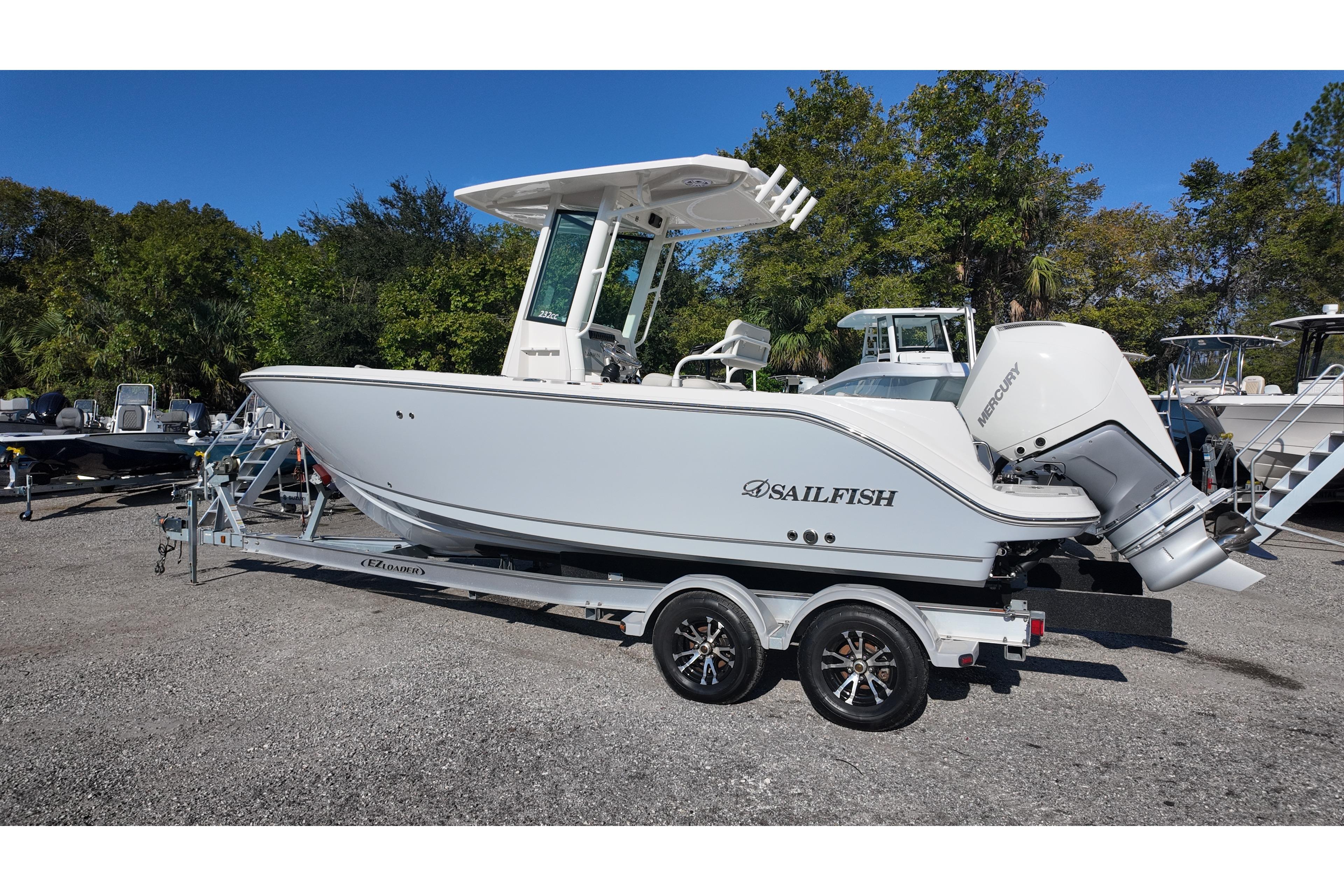 2026 Sailfish 232 CC boat on trailer, parked outdoors with trees in background.