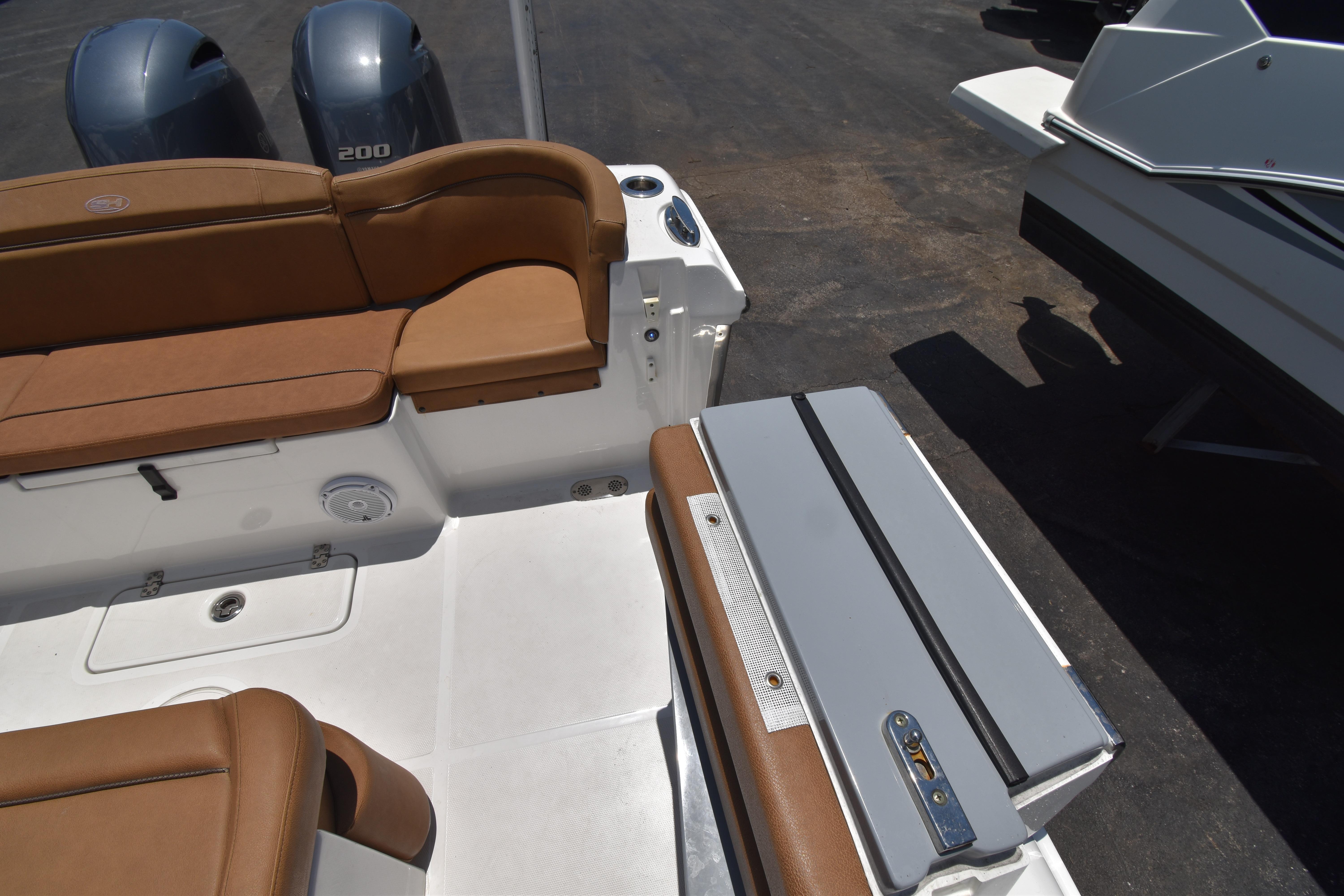 2020 Sea Hunt Ultra 275 SE boat interior with brown seating and dual engines.
