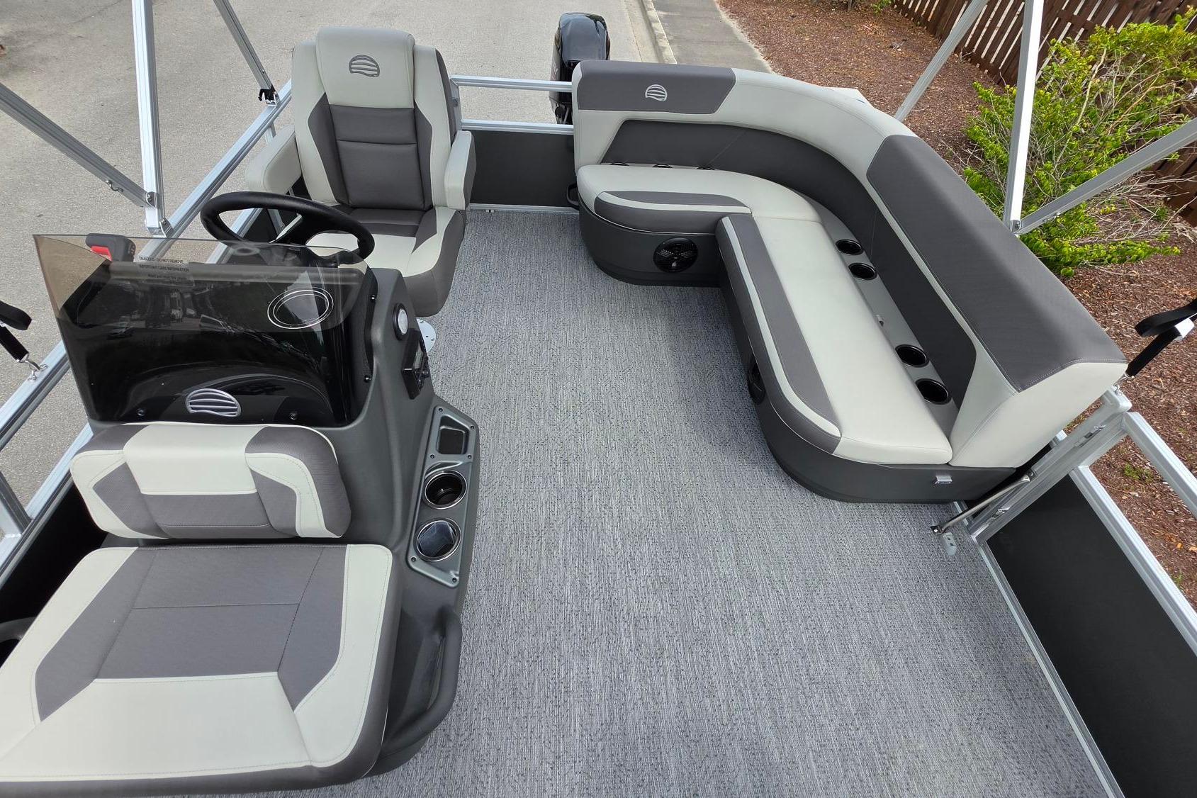 2026 Sun Tracker Bass Buggy 16 XL Select pontoon boat interior with seating and steering console.