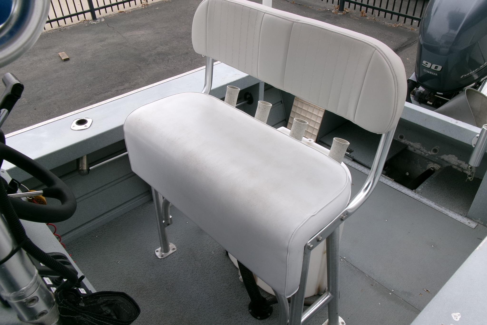 2017 Klamath Bayrunner 19 Baja boat interior with white cushioned seating and rod holders.