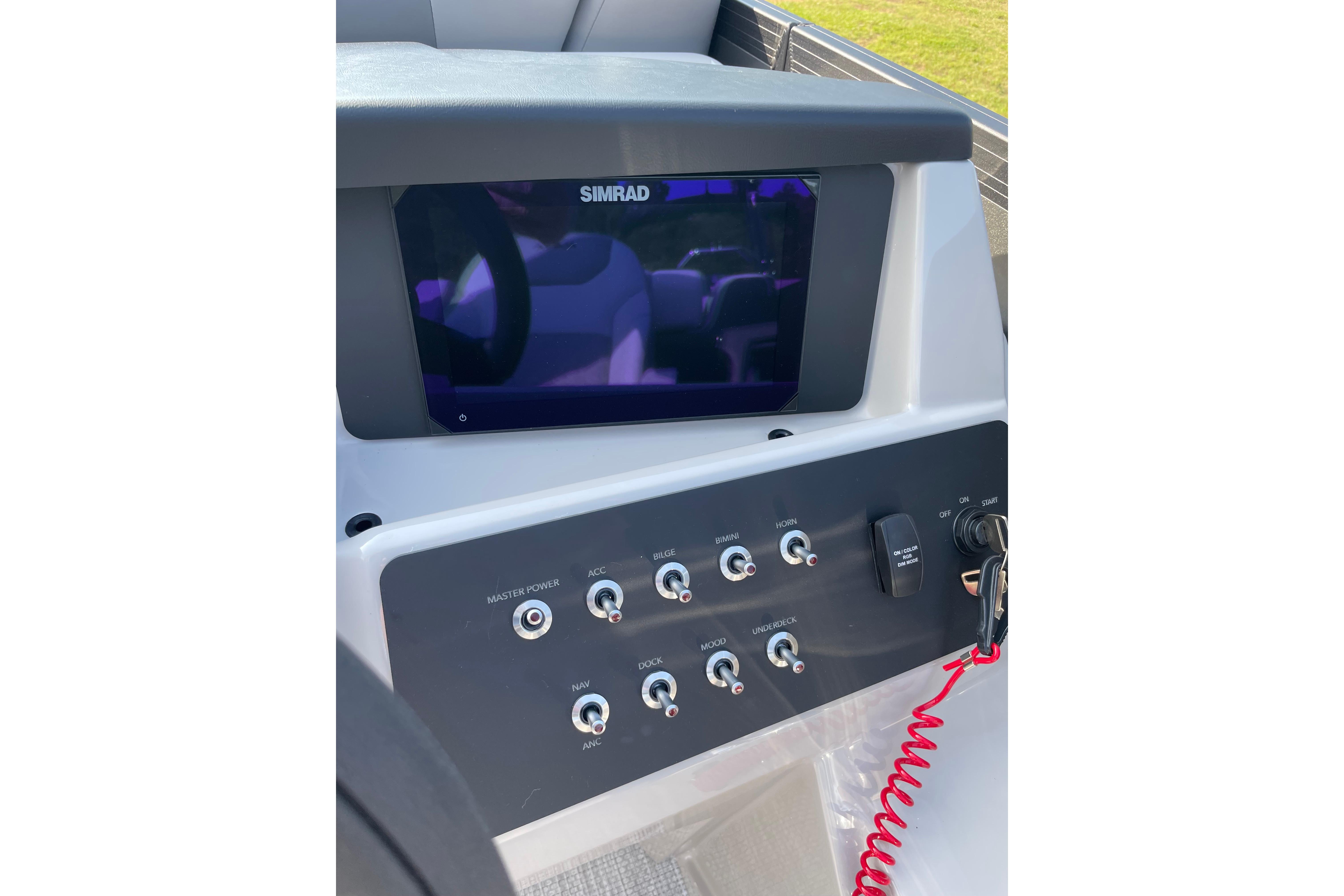 Control panel of 2027 Alera a24 boat with Simrad display and switches.