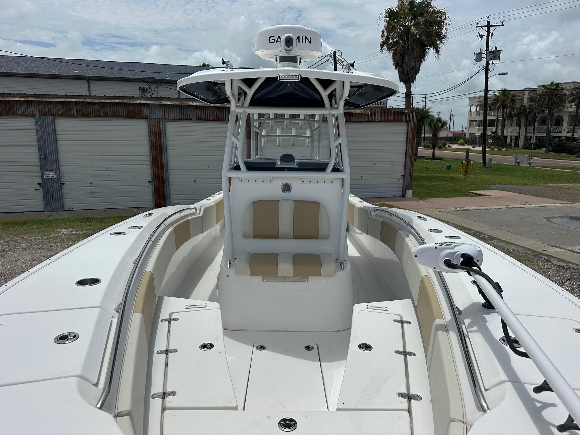 2023 Cape Horn 32xs boat with Garmin equipment, docked near storage units.