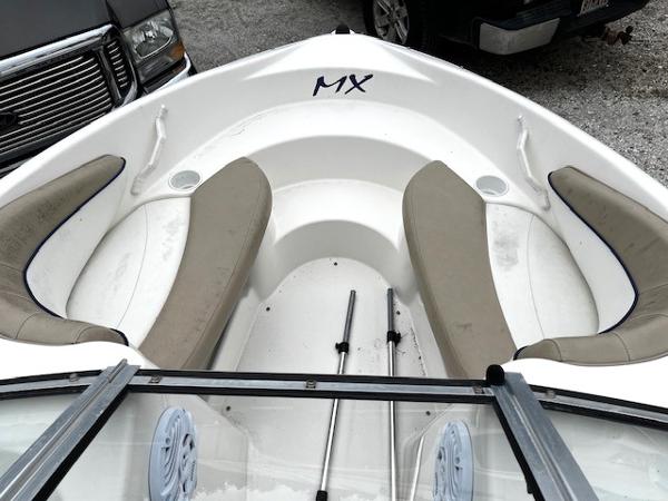 2005 Glastron MX boat interior with beige seating and white hull.