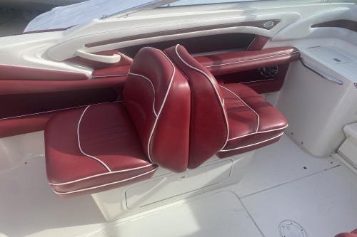 1997 Sea Ray 230 Overnighter boat with red leather seating and white accents.
