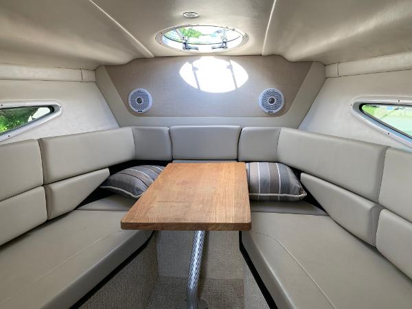 Interior of a 2017 Regal 26 Express with seating area and wooden table.