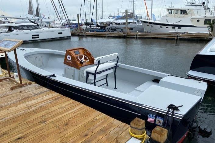 2024 C.W. Hood 26E Electric Runabout docked at a marina, showcasing sleek design.