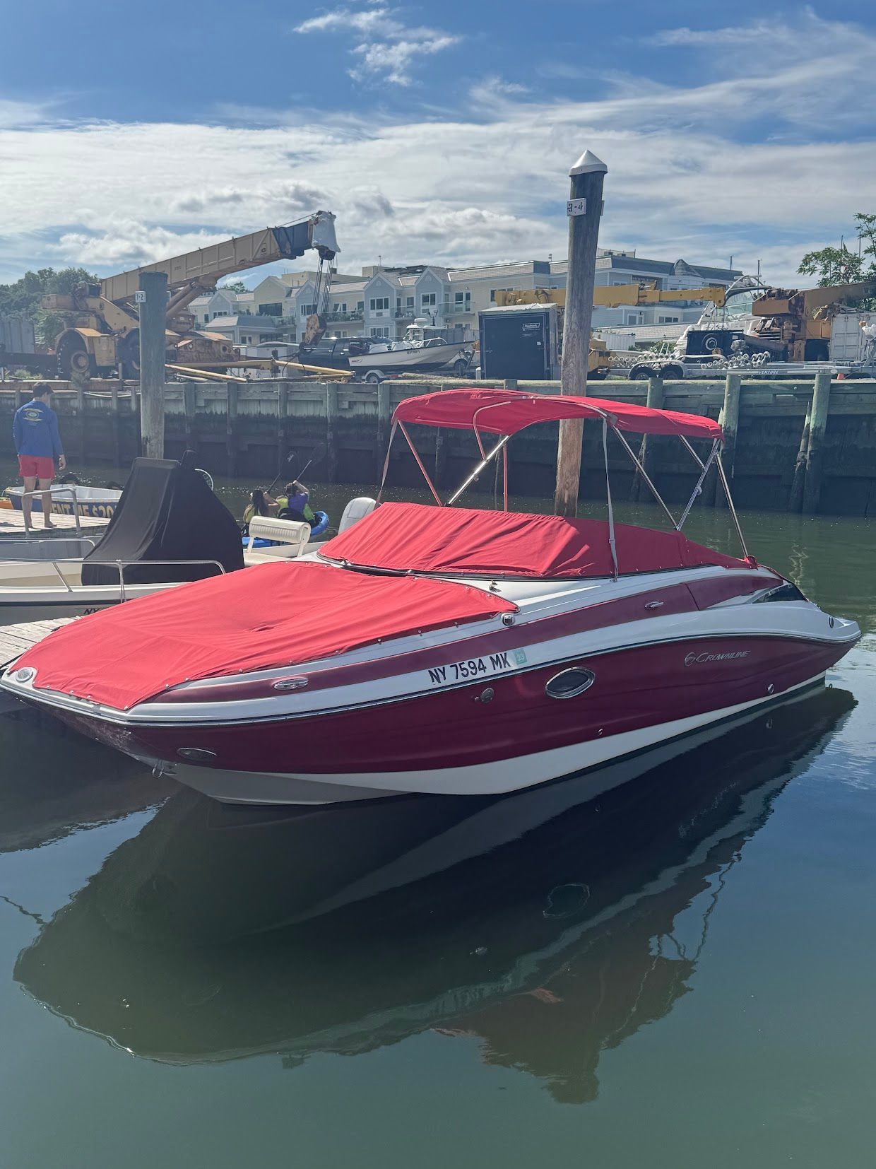 2014 Crownline Eclipse E2 boat docked with red cover.