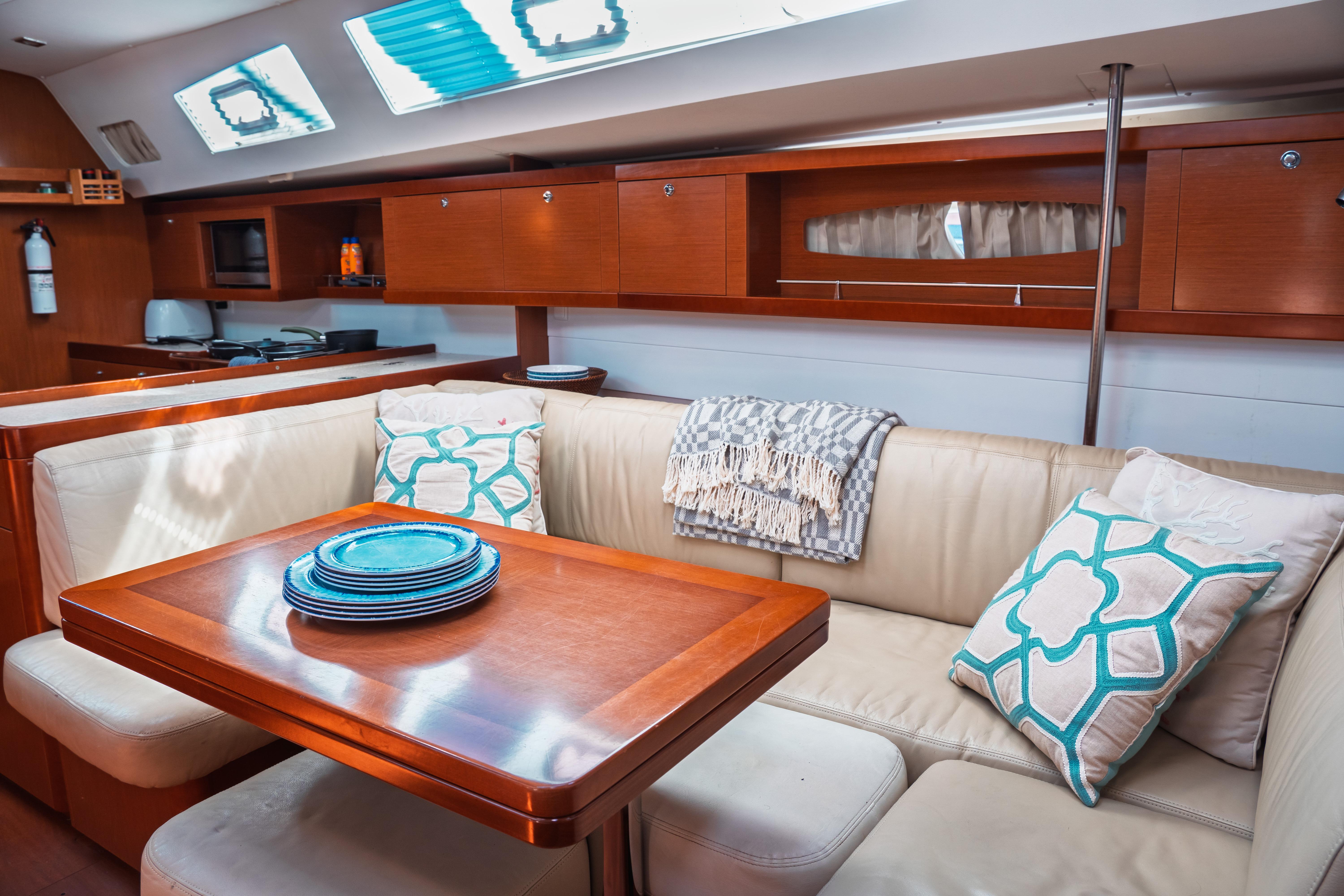 Luxurious interior of 2011 Beneteau Oceanis 50 yacht with elegant seating and dining area.