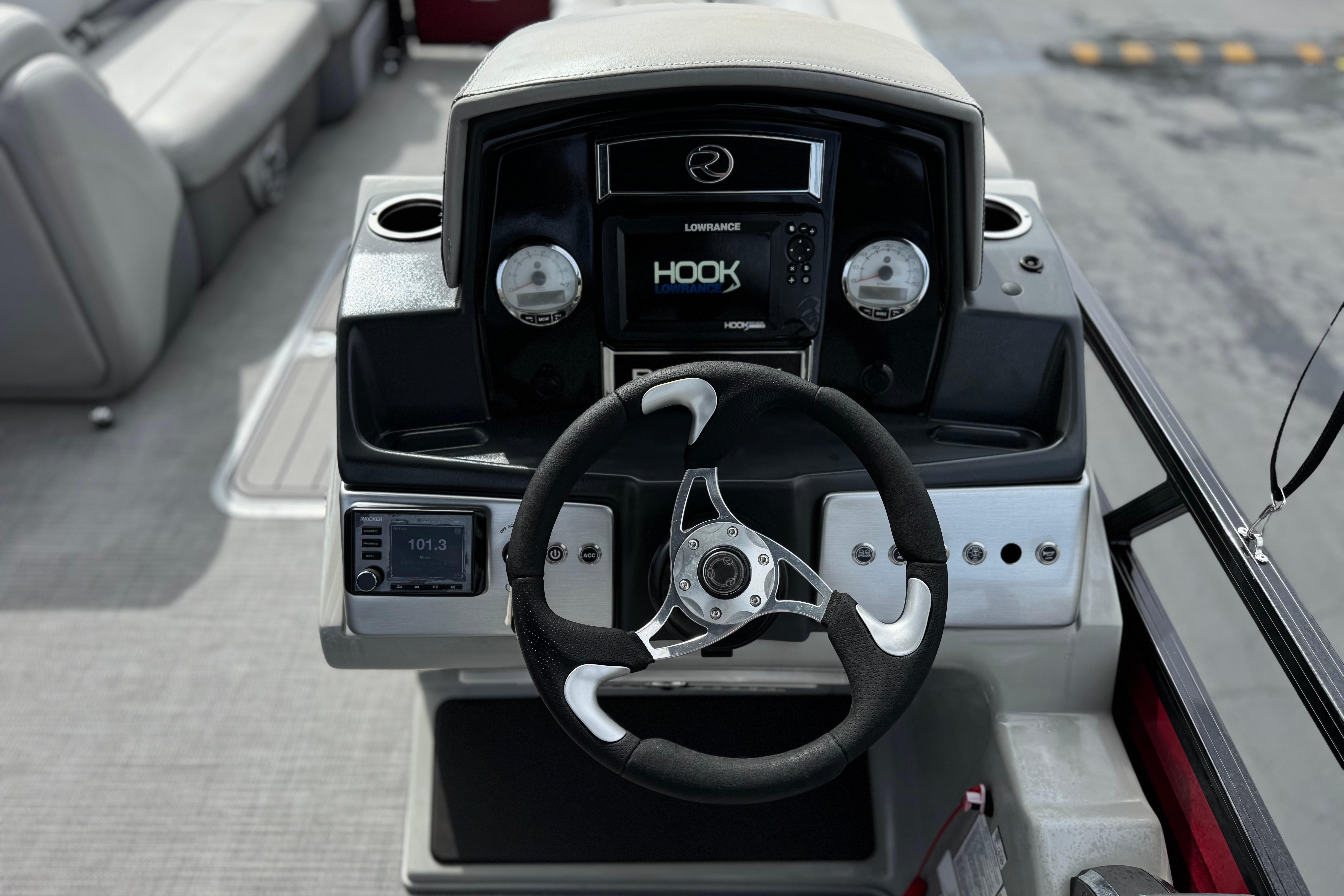 Steering console of 2022 Regency 250 DL3 boat with modern navigation system.