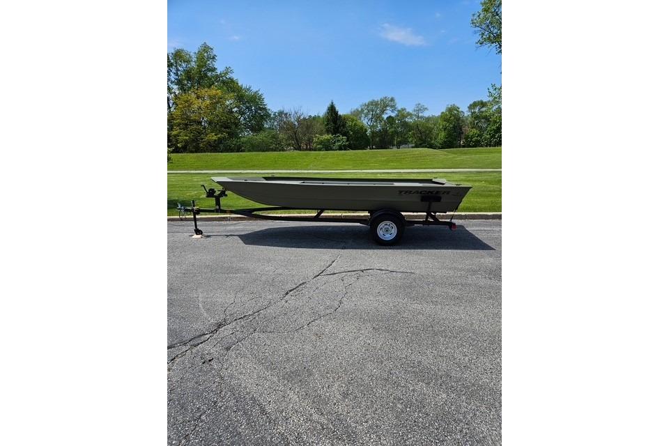 2026 Tracker Grizzly 1754 Utility boat on trailer, parked on asphalt with grassy background.