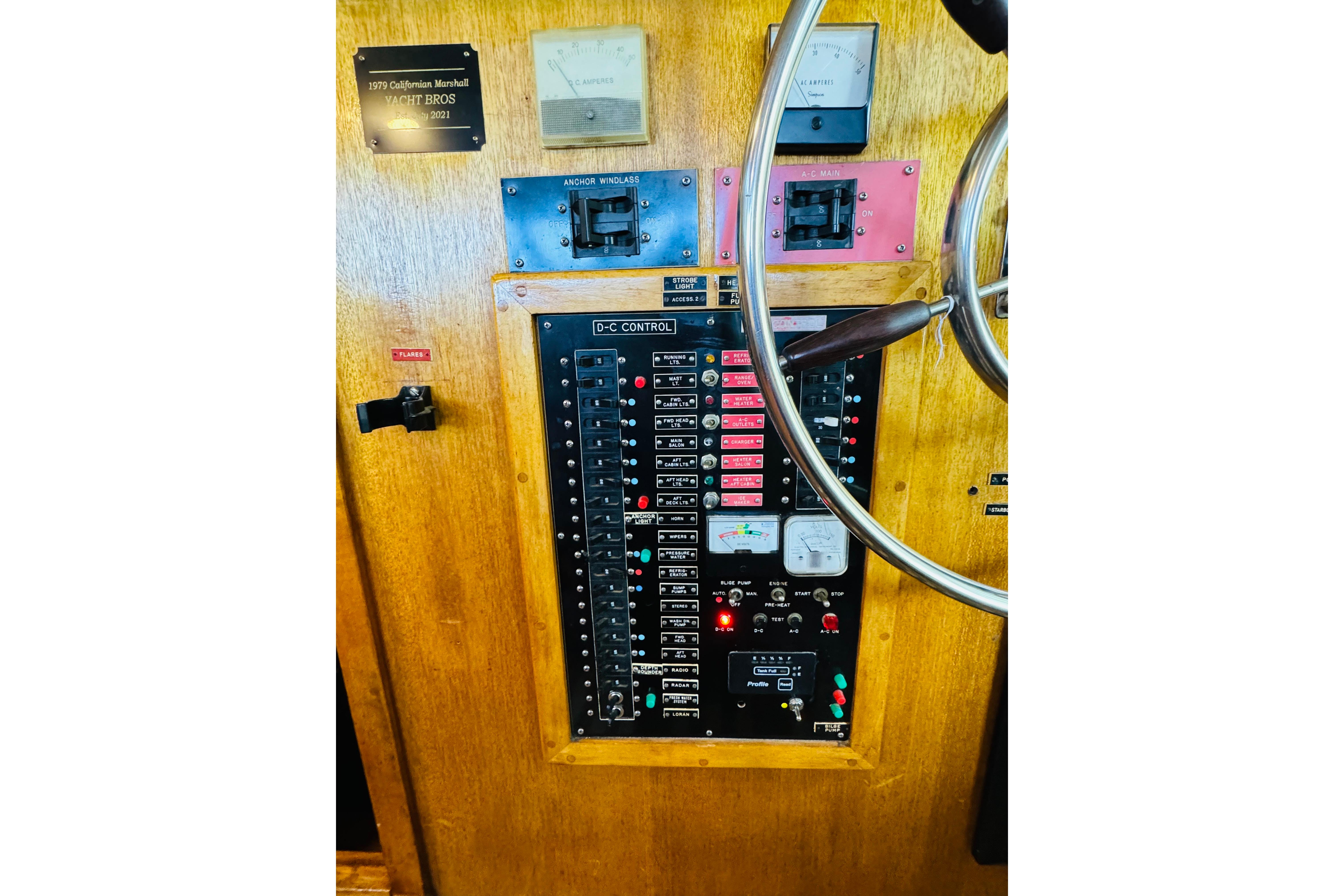 Control panel of a 1978 Californian 42 LRC yacht with steering wheel and gauges.