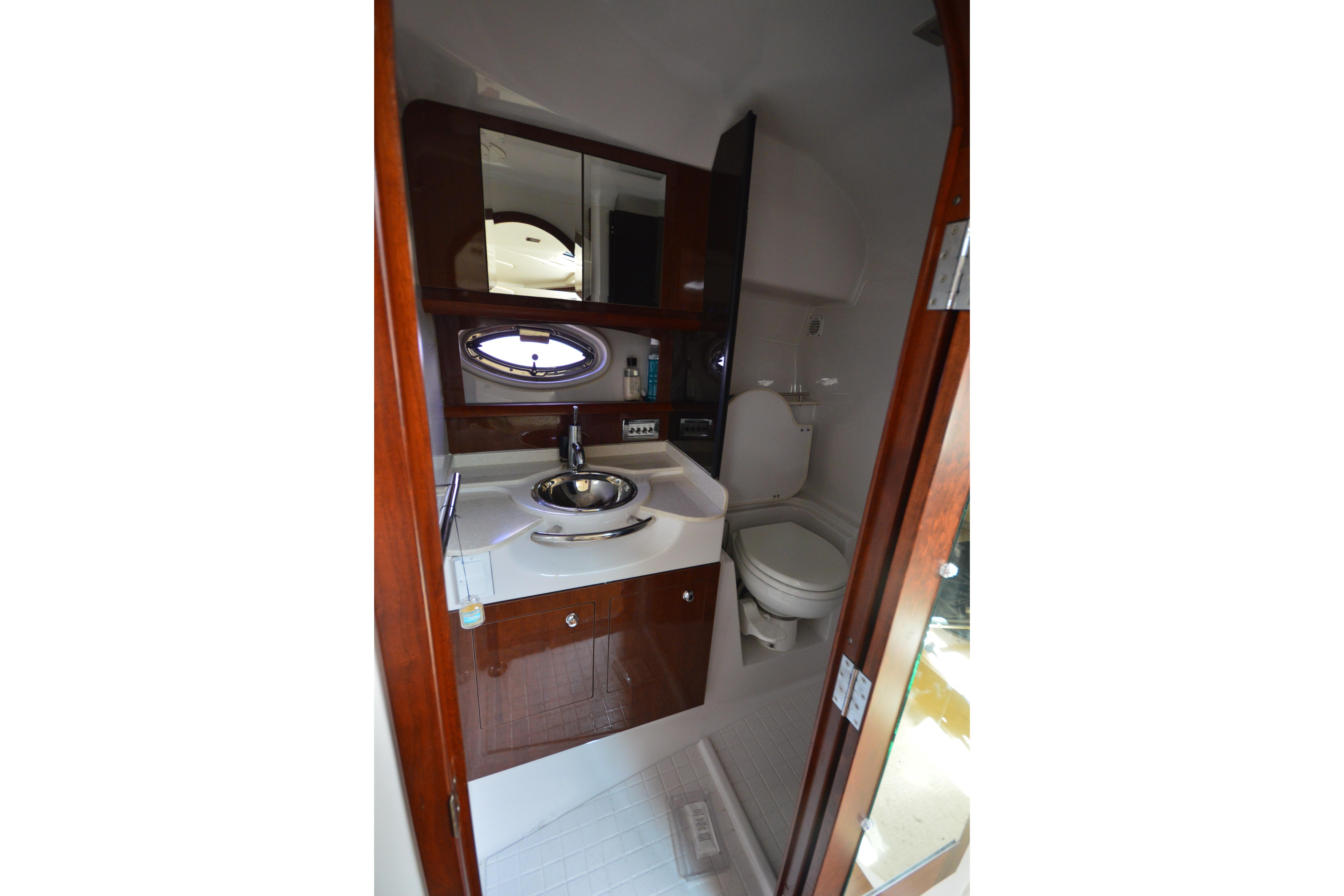 Luxurious 2013 Four Winns V375 yacht bathroom with sink, toilet, and mirror.