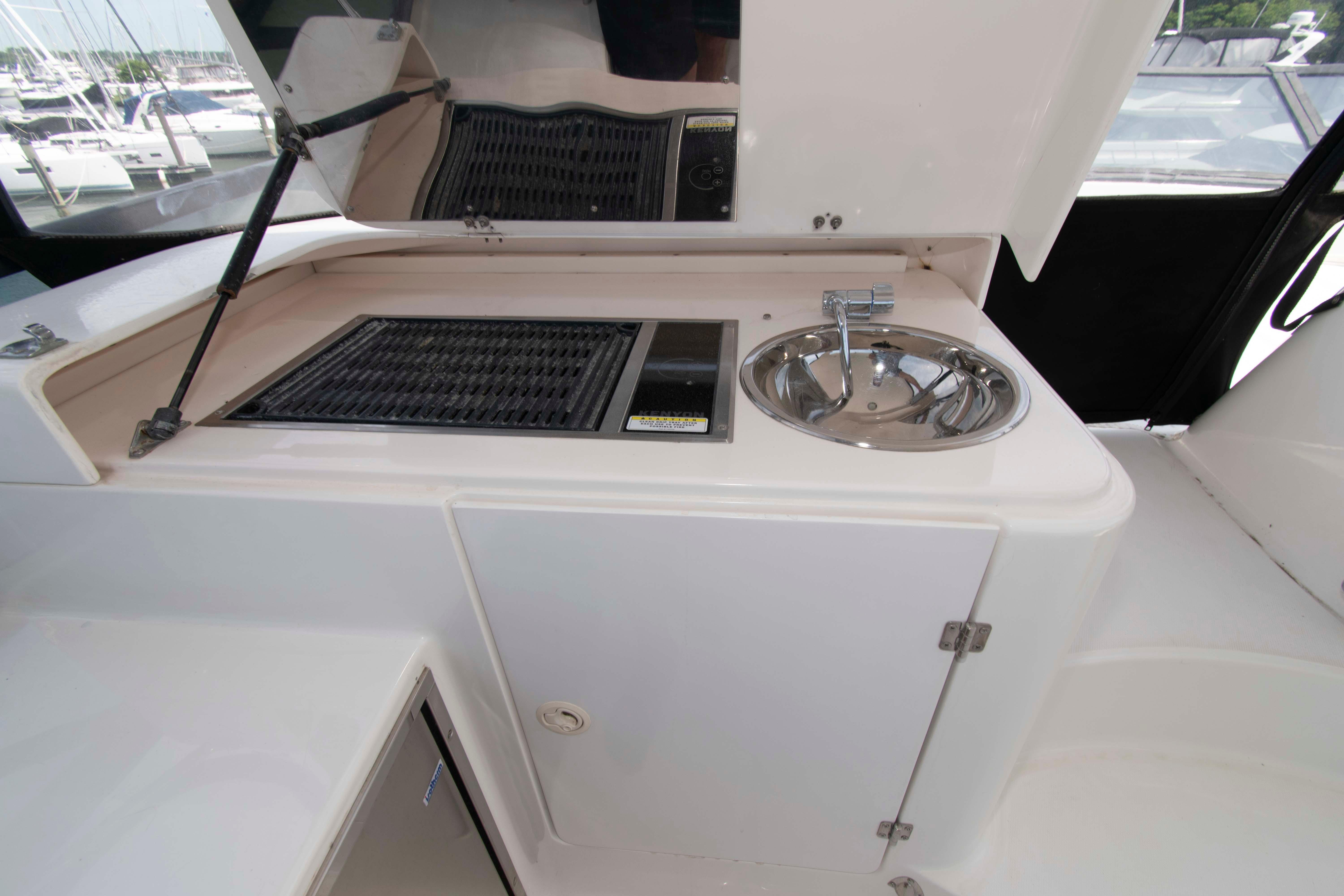 2003 Neptunus 56 Flybridge yacht kitchenette with sink and grill.