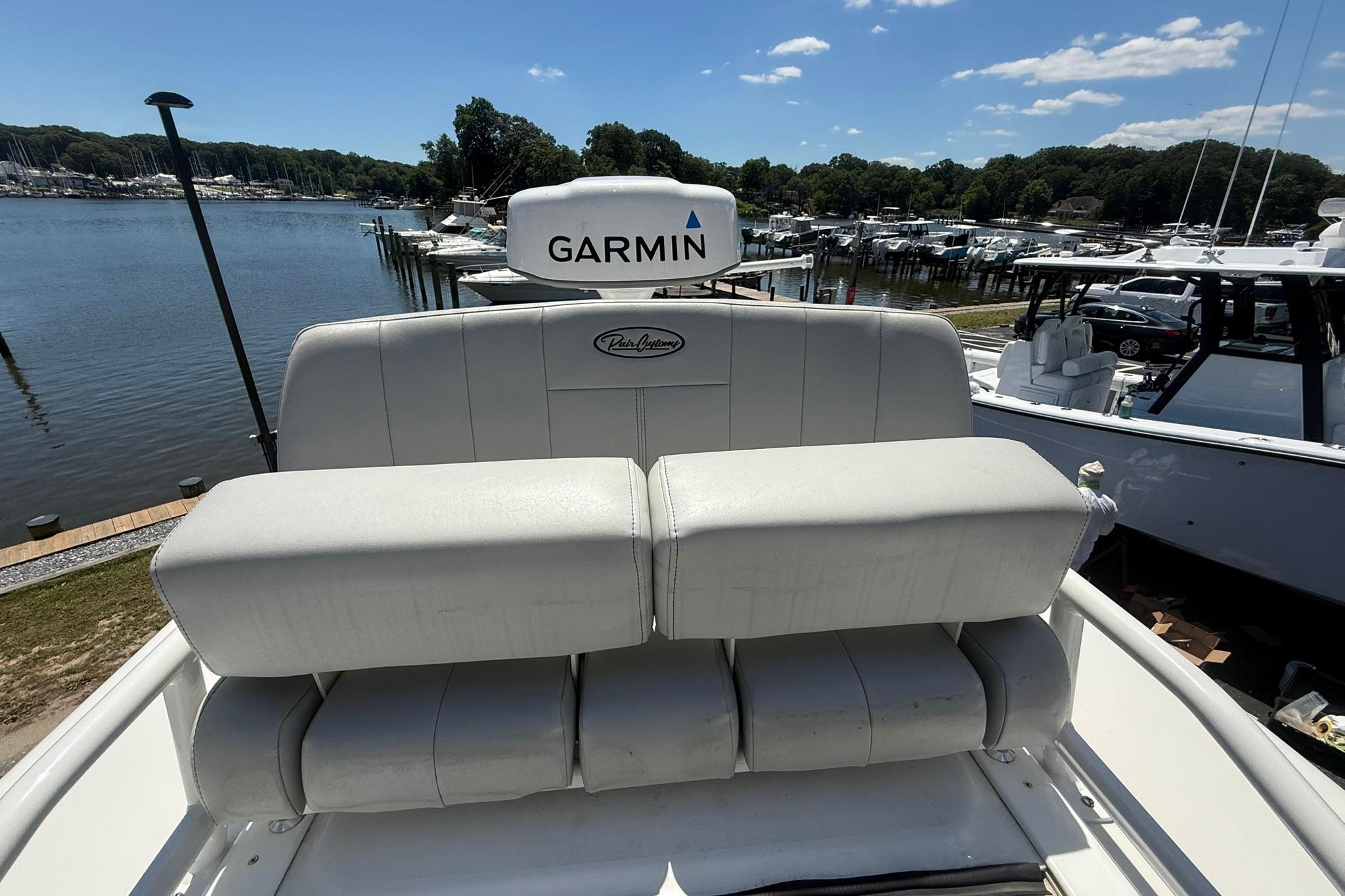 2024 Pair Customs 24 Center Console MV boat with Garmin equipment at a marina.