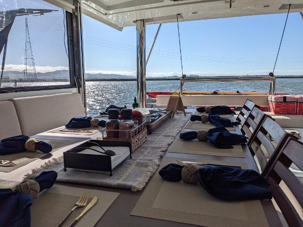 Dining setup on a 2021 Bali 4.8 catamaran with ocean view.