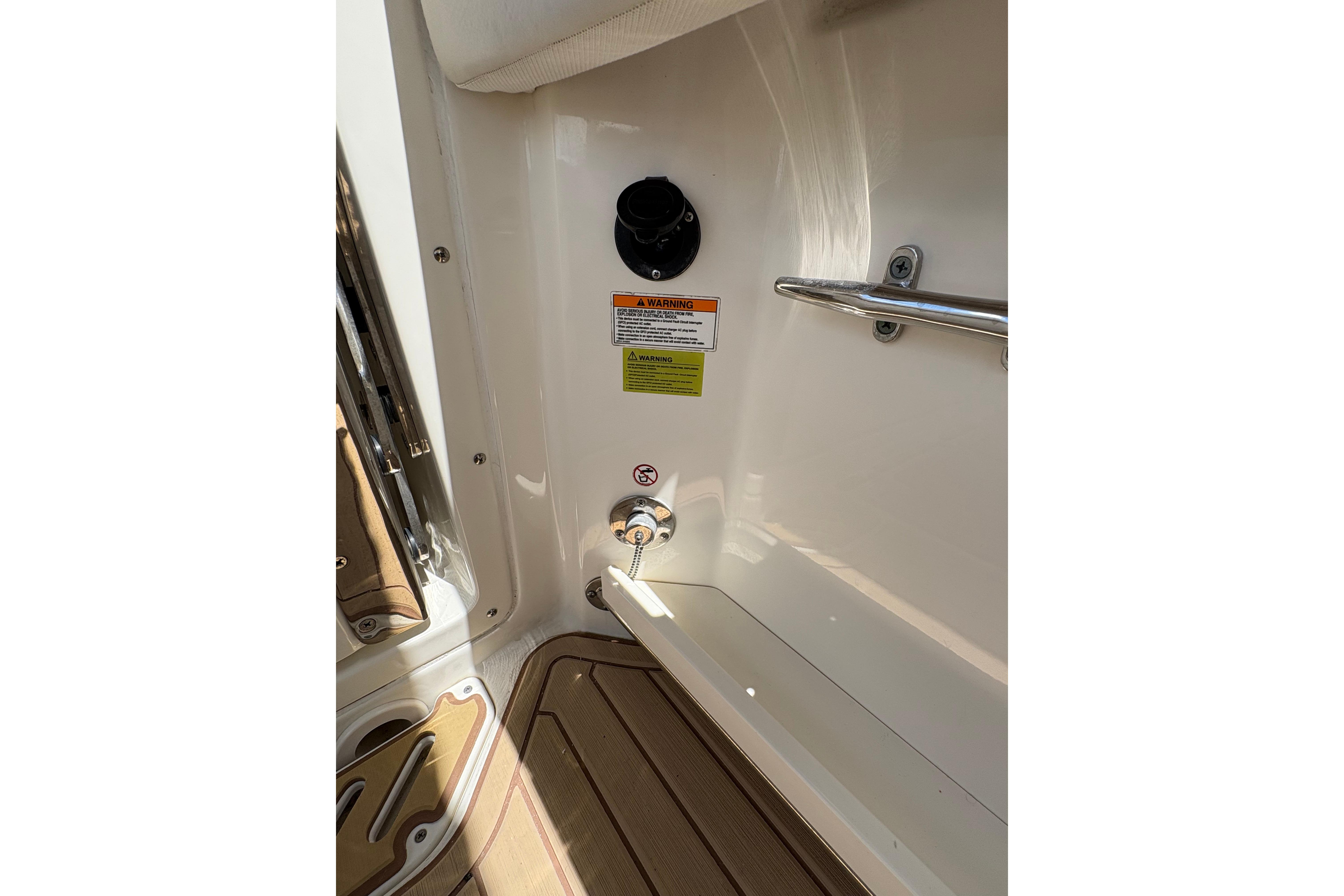 2017 Boston Whaler 270 Vantage interior detail with safety warnings and fittings.