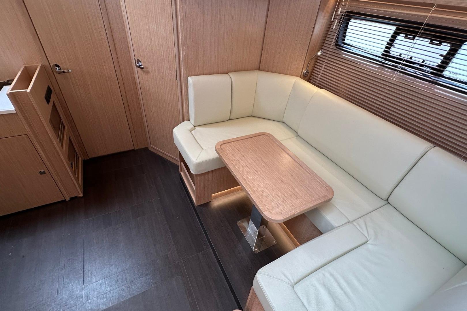 Luxurious interior of 2023 Bavaria SR41 yacht with elegant seating and wooden accents.