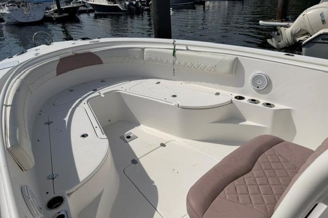 2014 Edgewater 318CC boat interior with cushioned seating and storage compartments.