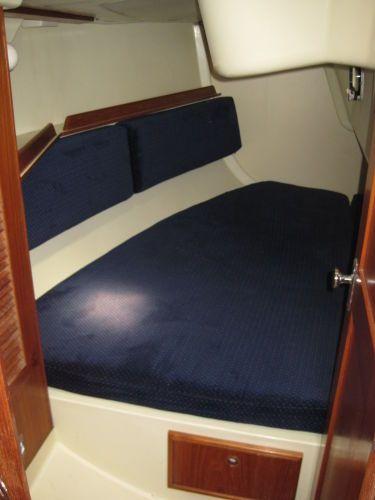 1986 Pearson 36-2 sailboat cabin with blue cushions and wooden accents.