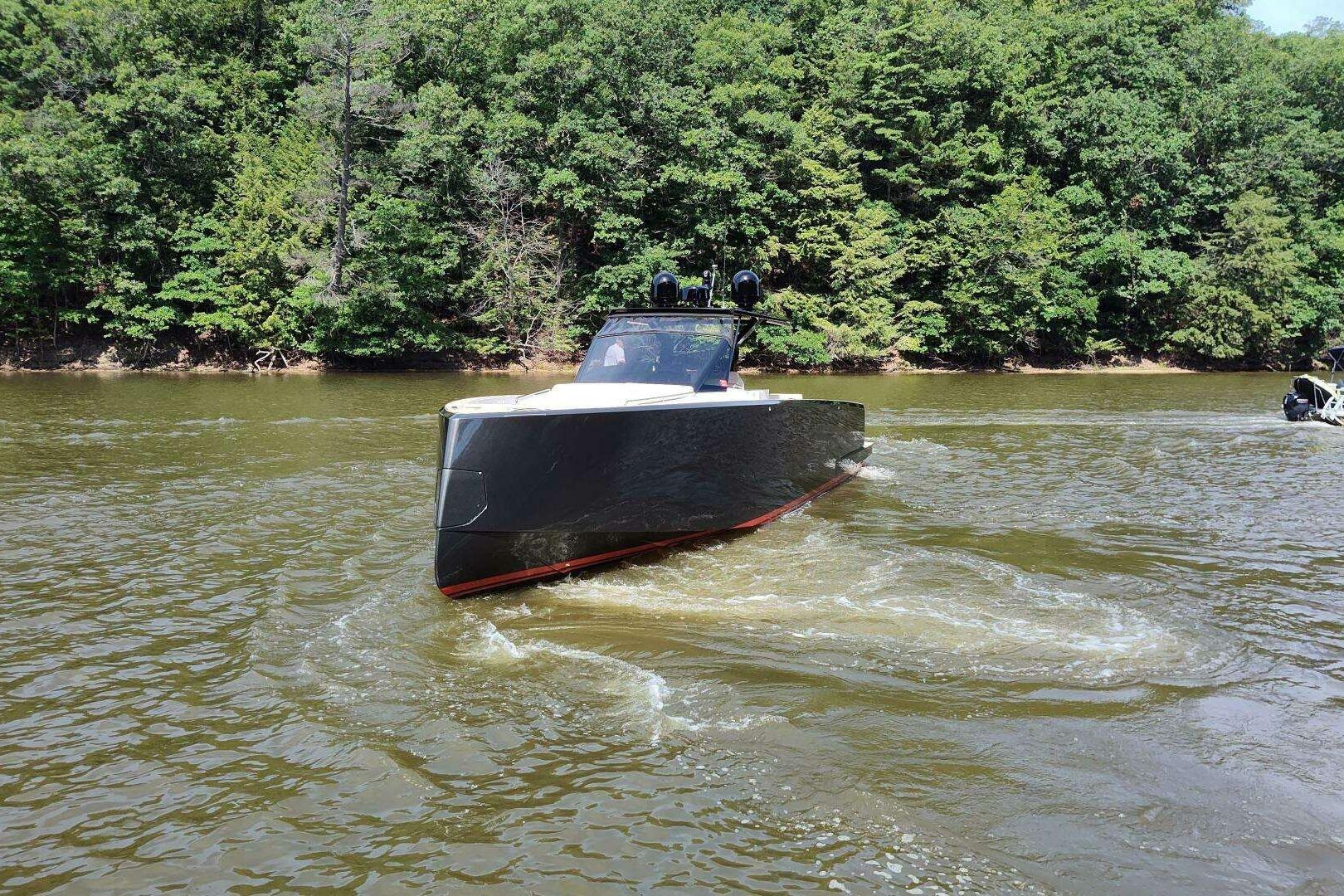 2023 Pardo Yachts P43 cruising on a scenic river with lush green forest backdrop.