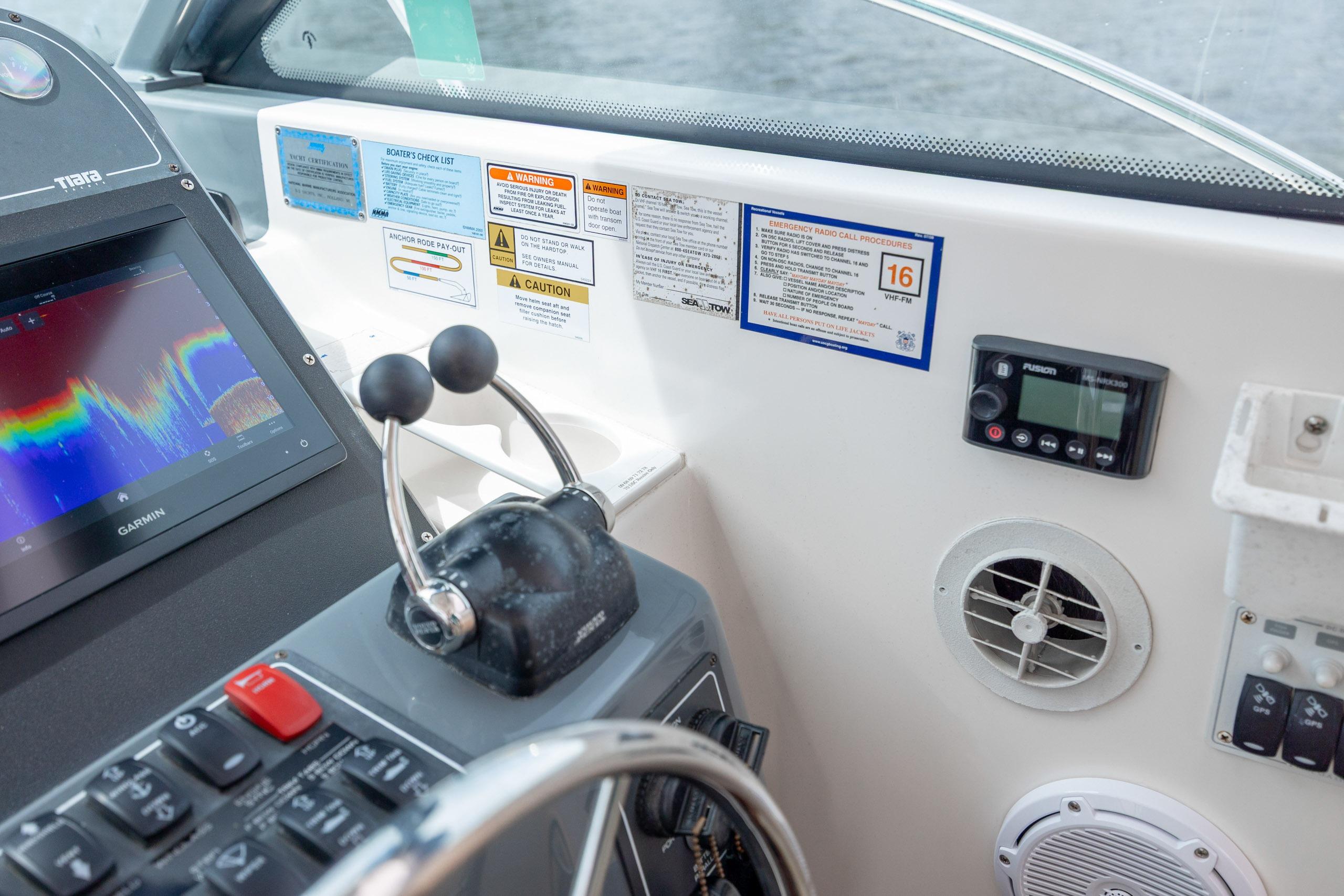 2004 Tiara Yachts 3200 Open helm with Garmin display and control panel.