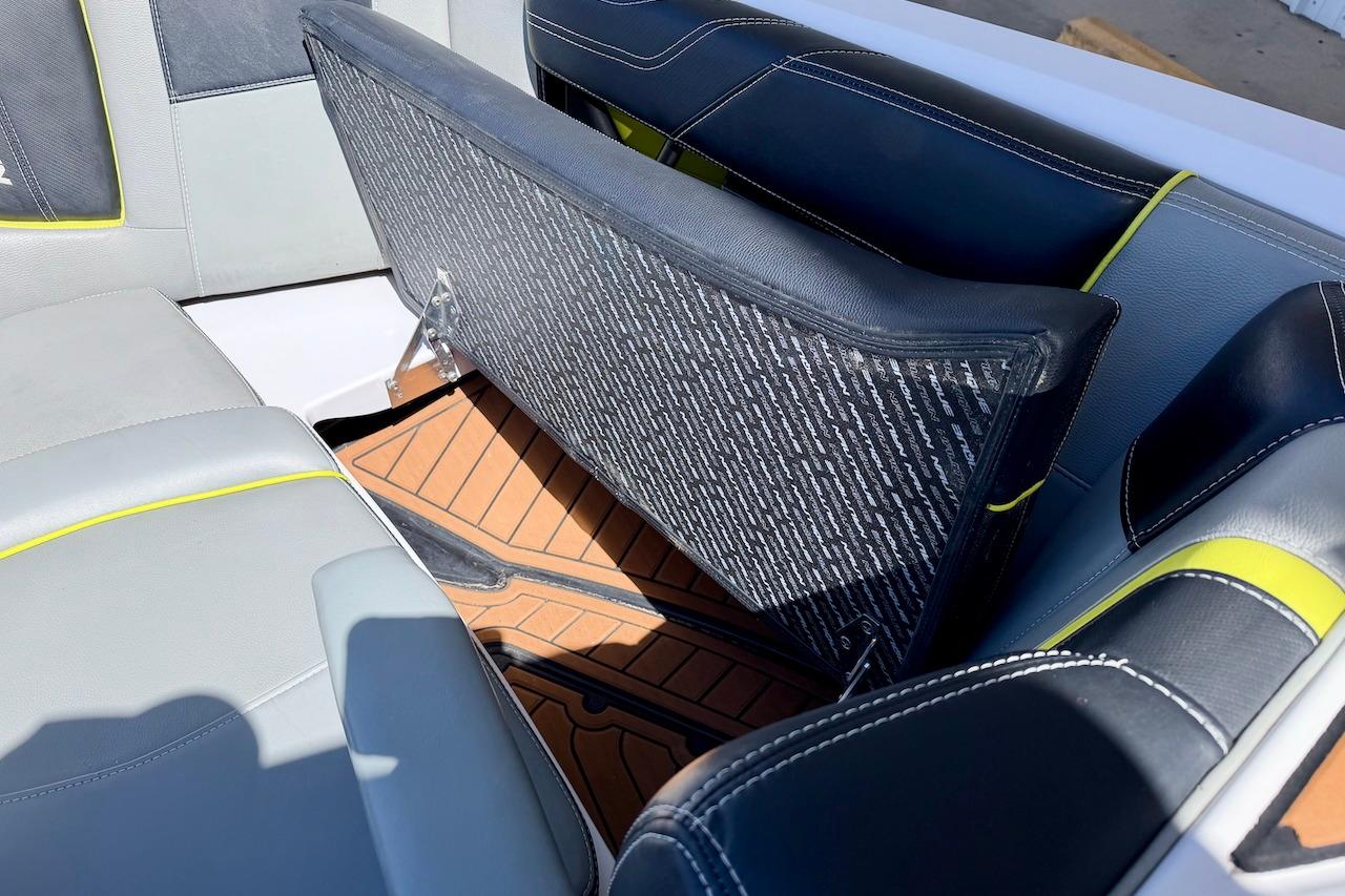 2014 Nautique Super Air Nautique G21 interior with open storage compartment.