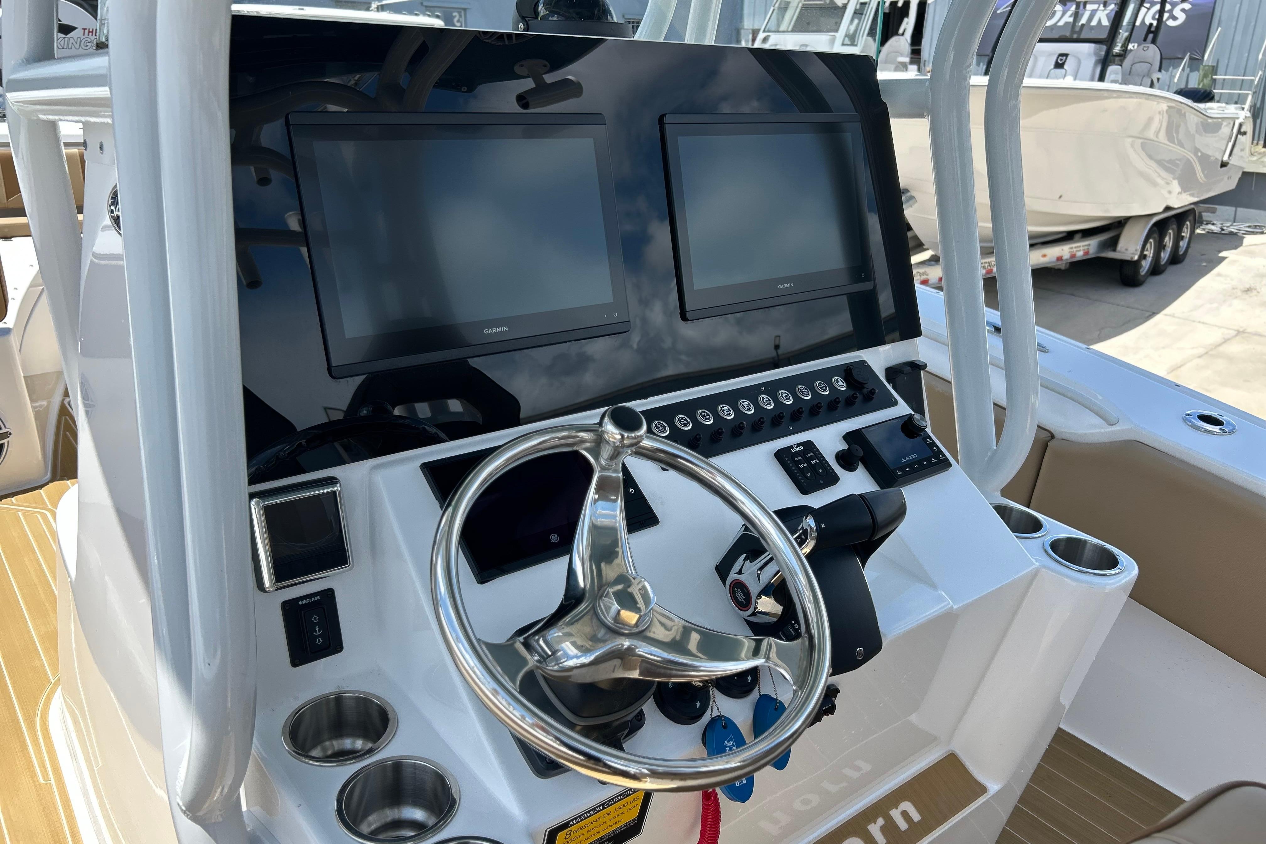 2025 Cape Horn 34 XS boat dashboard with dual screens and steering wheel.
