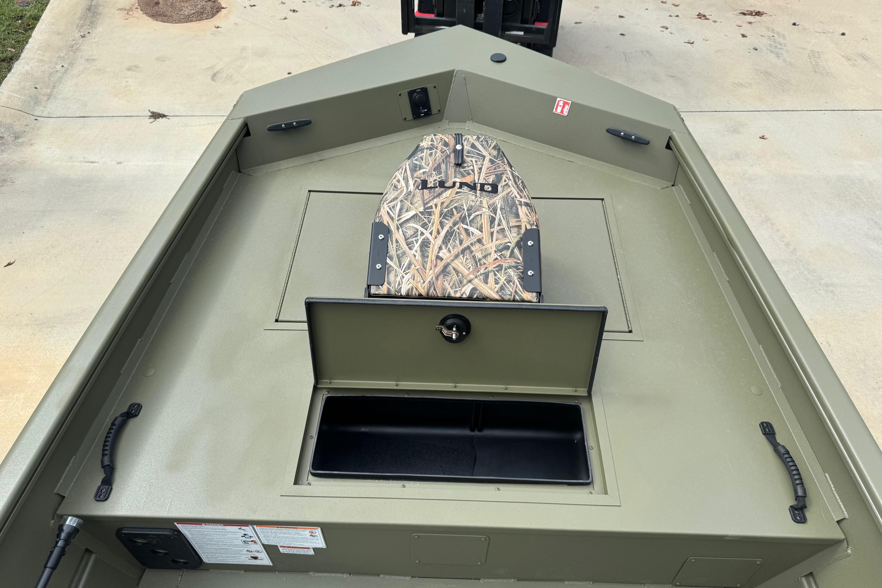 2026 Lund 1760 Predator SC boat interior with storage compartment and camo seat.