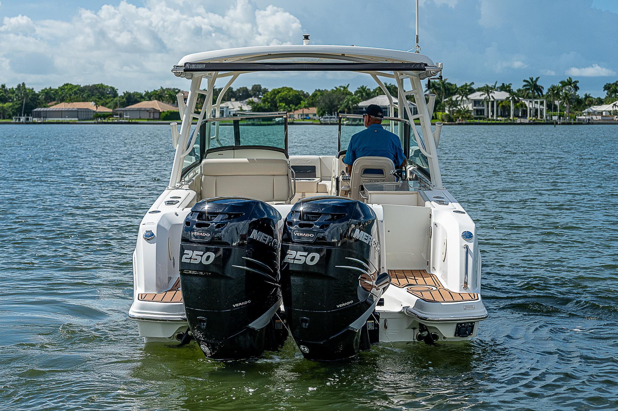 2018 Boston Whaler 270 Vantage boat with dual 250 engines on a calm lake.