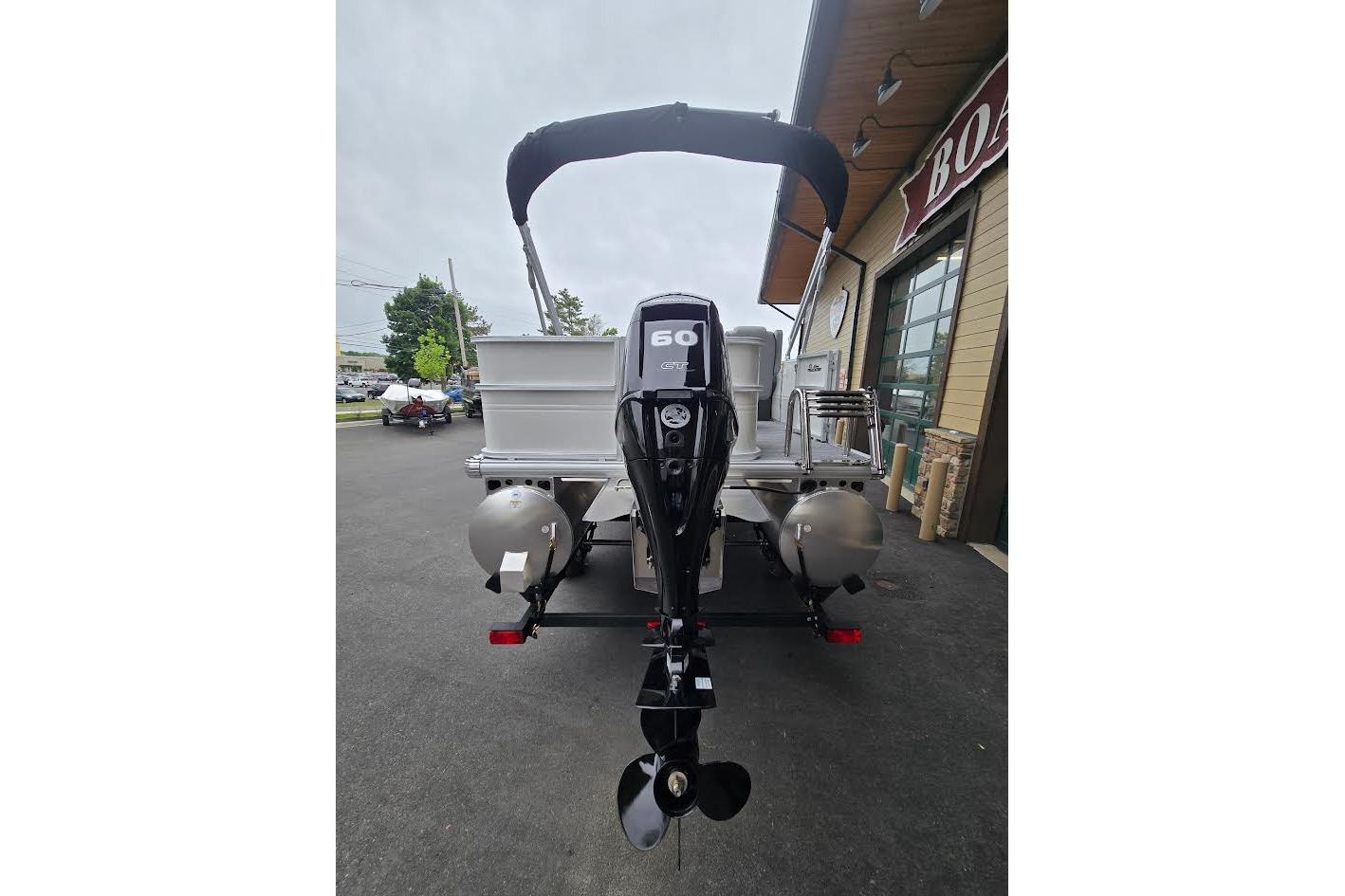2026 Sun Tracker Party Barge 18 DLX pontoon boat with 60 HP outboard motor.