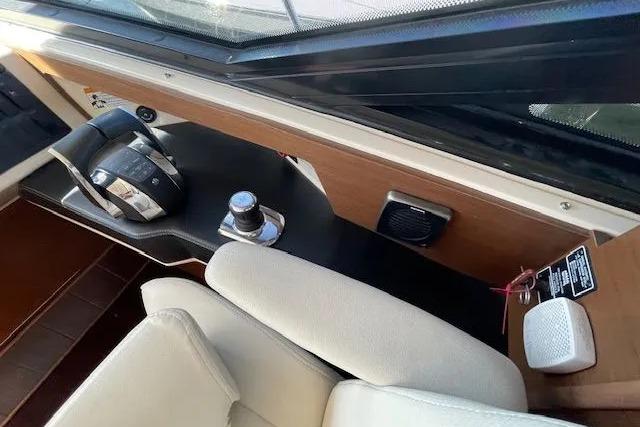 Interior helm of 2016 Sea Ray Sundancer 510 yacht, featuring modern controls and seating.