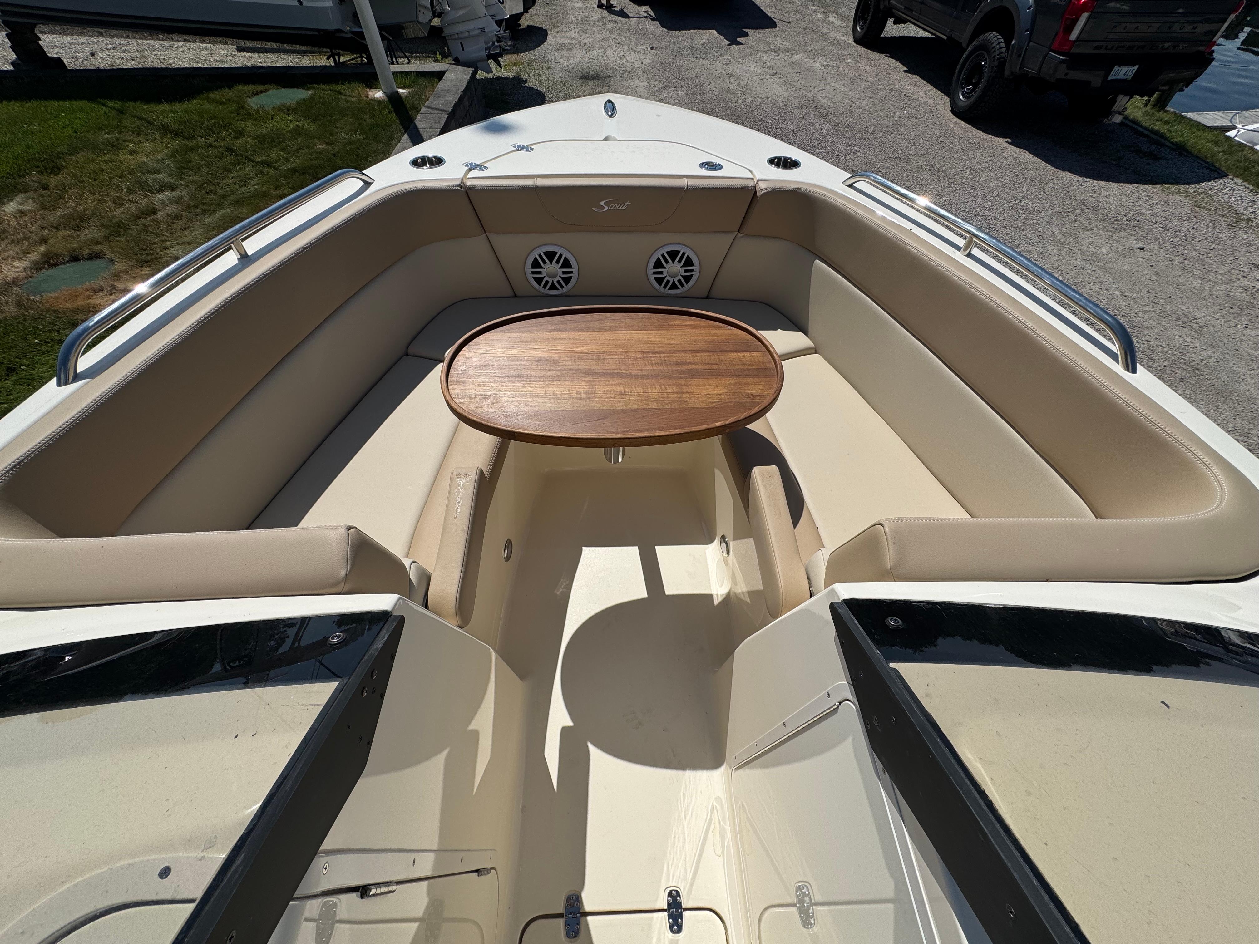 2025 Scout 215 Dorado boat interior with seating and wooden table.