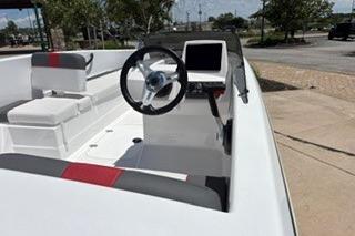 2026 Tahoe T16 boat with modern steering and seating, parked outdoors.