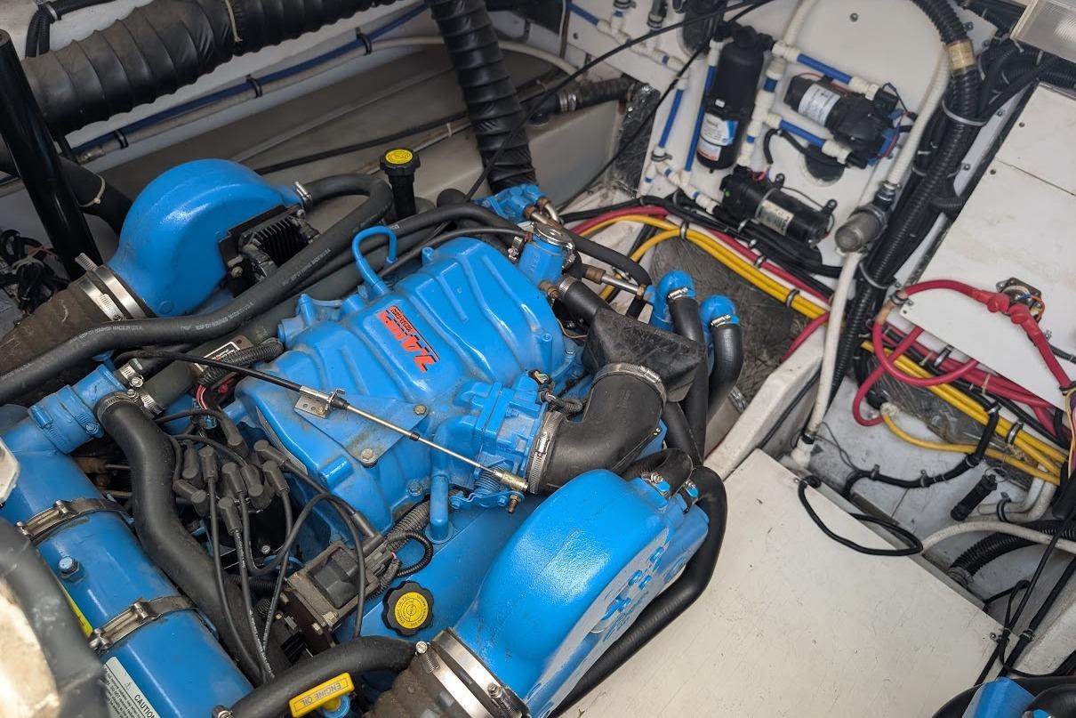 Engine compartment of a 2000 Pursuit 3400 Express boat, featuring a blue engine.
