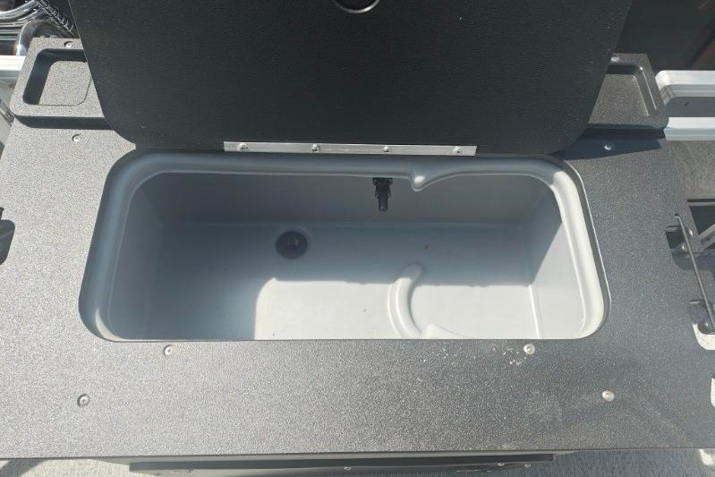 Open storage compartment on 2026 Sun Tracker Fishin' Barge 20 DLX boat.