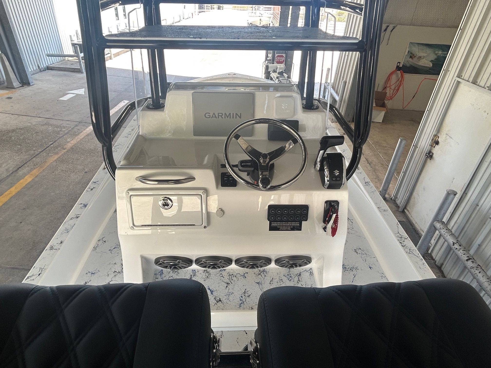 Interior view of 2023 Shallow Sport 25 X3 boat with helm console.