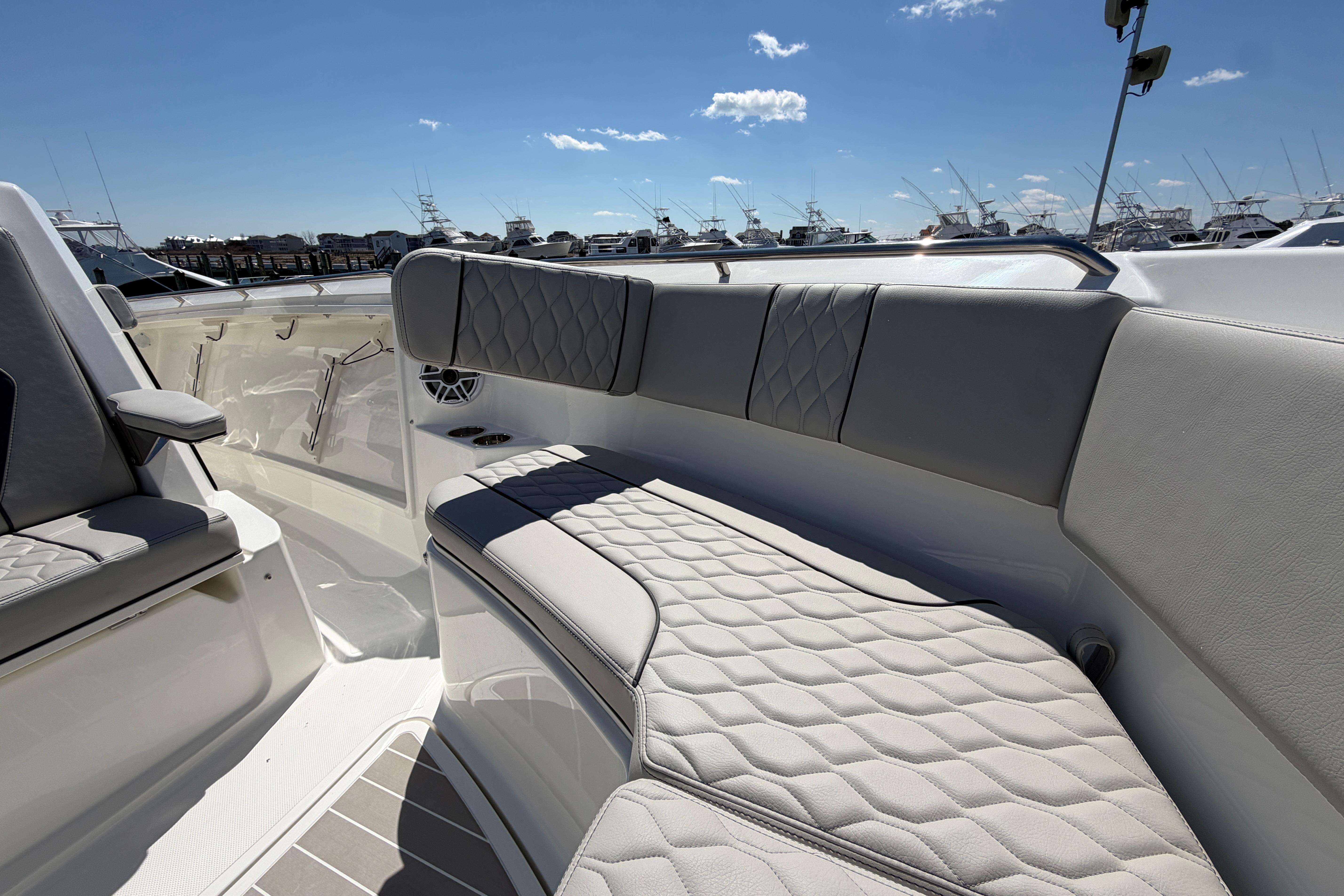 2026 Pursuit S 358 Sport boat interior with luxurious seating and clear blue sky.