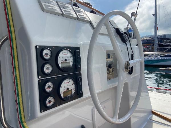 Vision 444 yacht steering wheel and control panel, docked at marina, 2025 model.