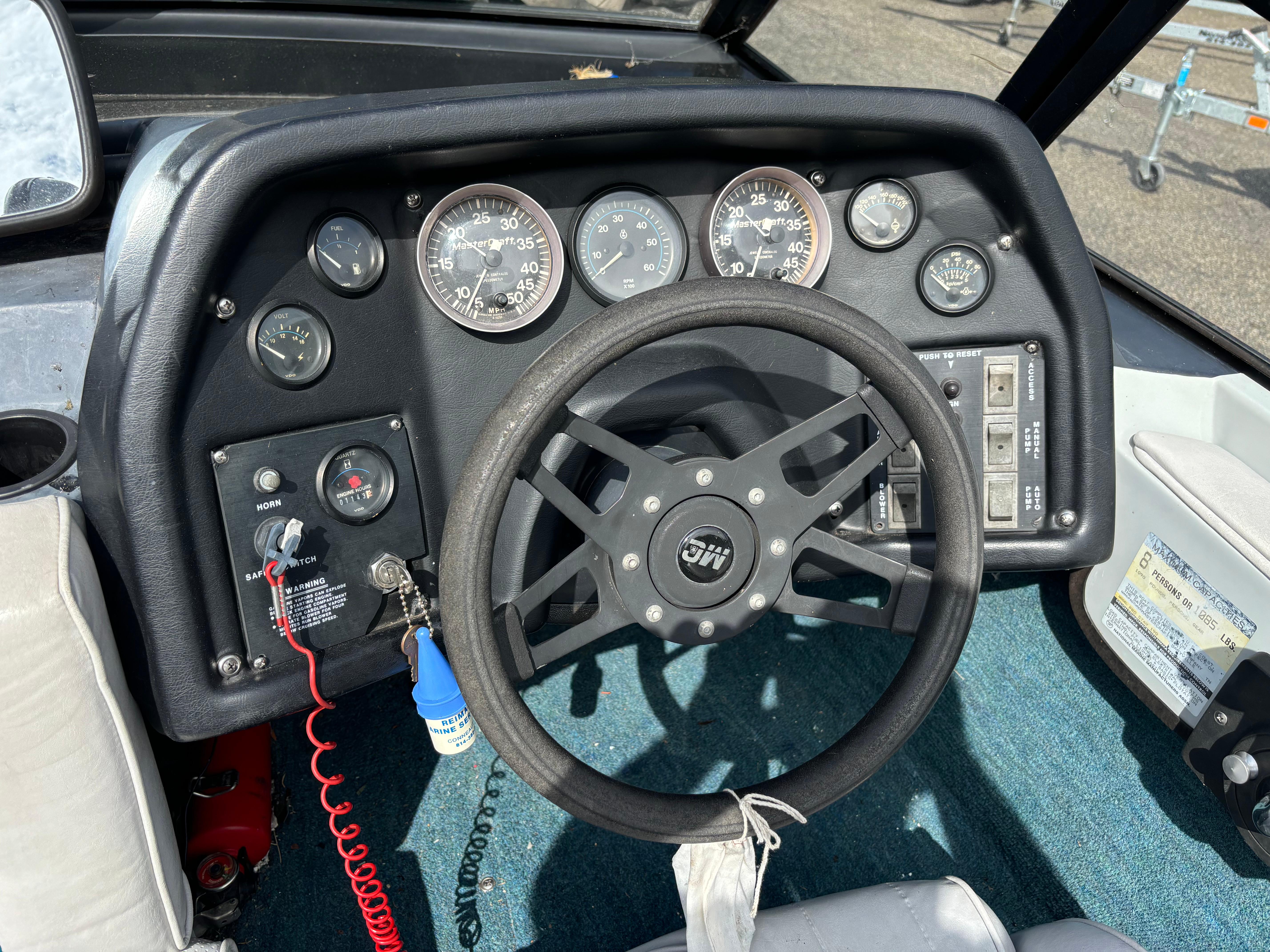 1989 MasterCraft ProStar 190 dashboard with steering wheel and gauges.
