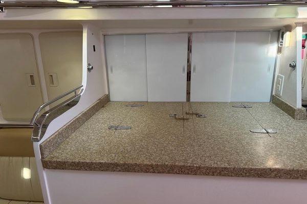 Luxurious interior of 2011 Reliance 44 yacht featuring a sleek countertop and storage cabinets.