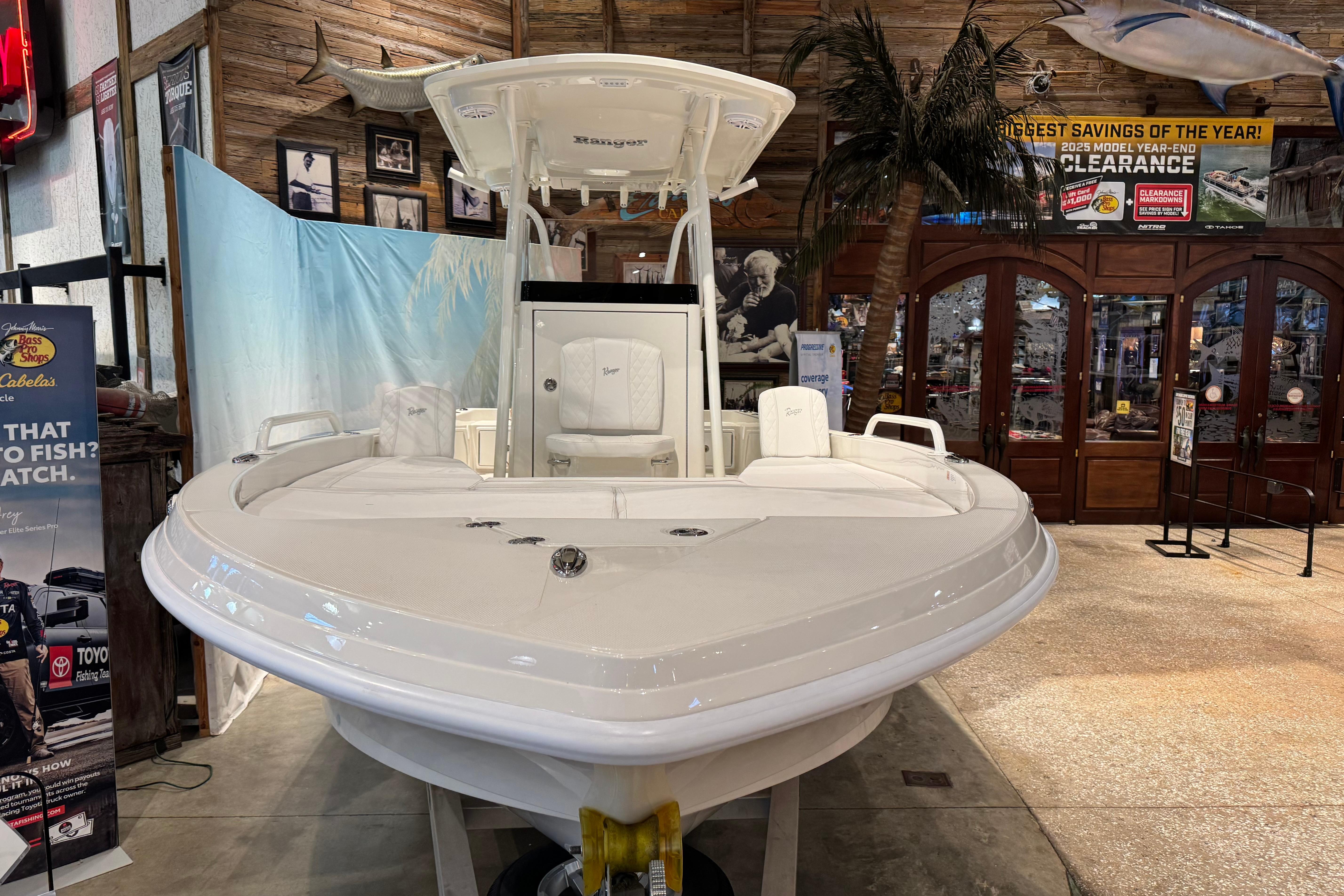 2025 Ranger 2360 Bay boat displayed in a showroom with promotional signage.