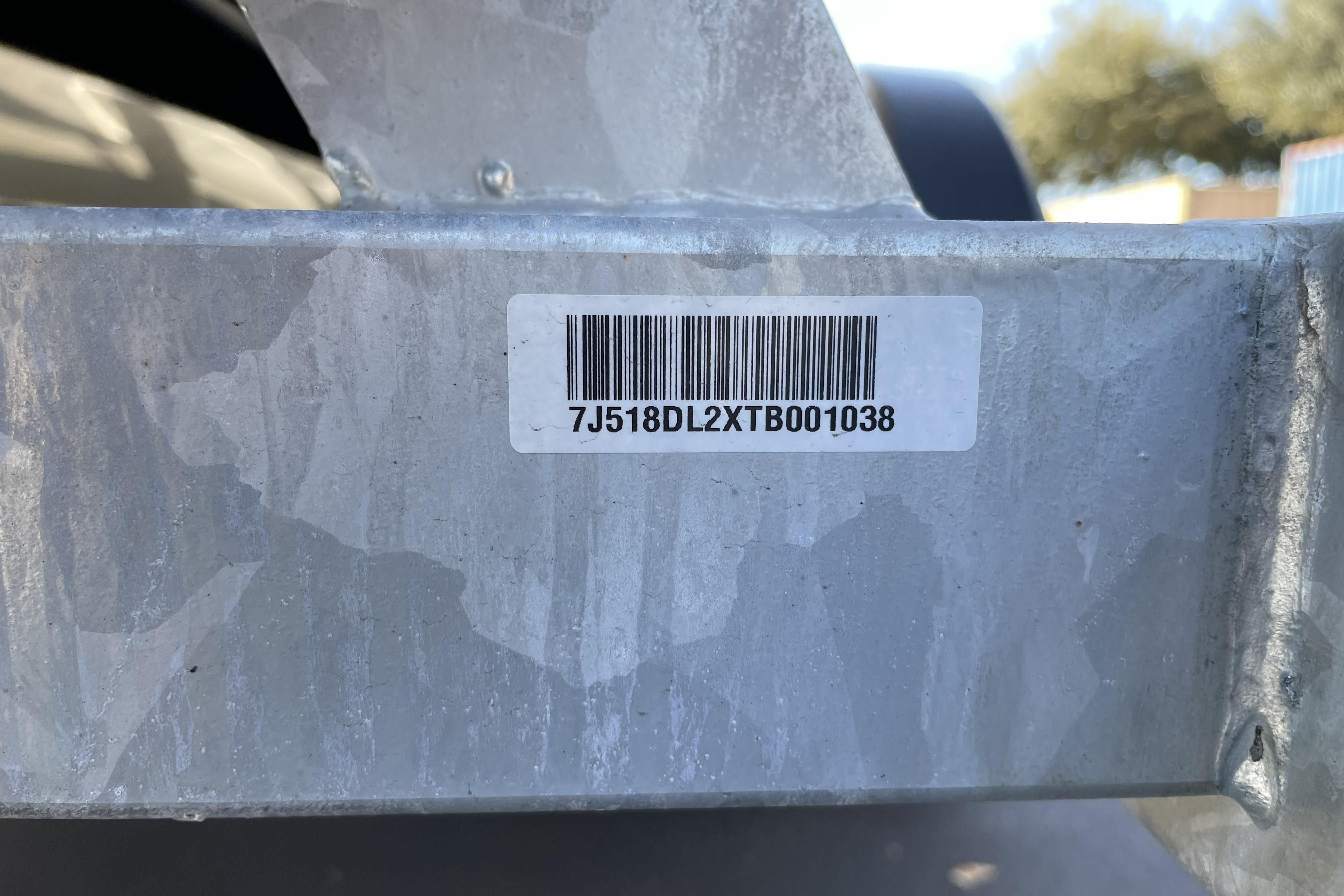 Barcode on metal surface of 2026 Mako Pro Skiff 19 CC boat trailer.